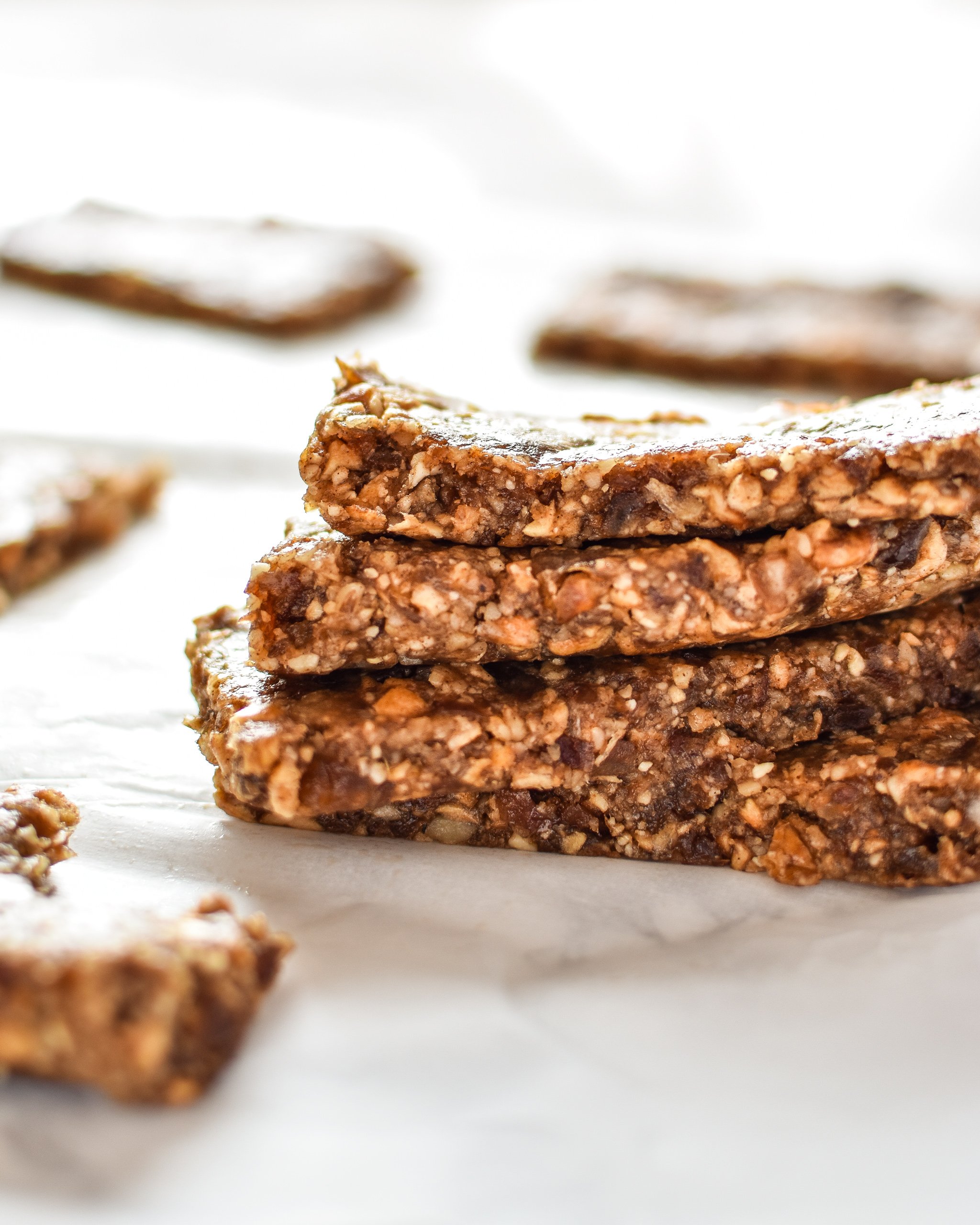 No-Bake Cinnamon Apple Date Bars stacked on one another, made with dates and dried apples