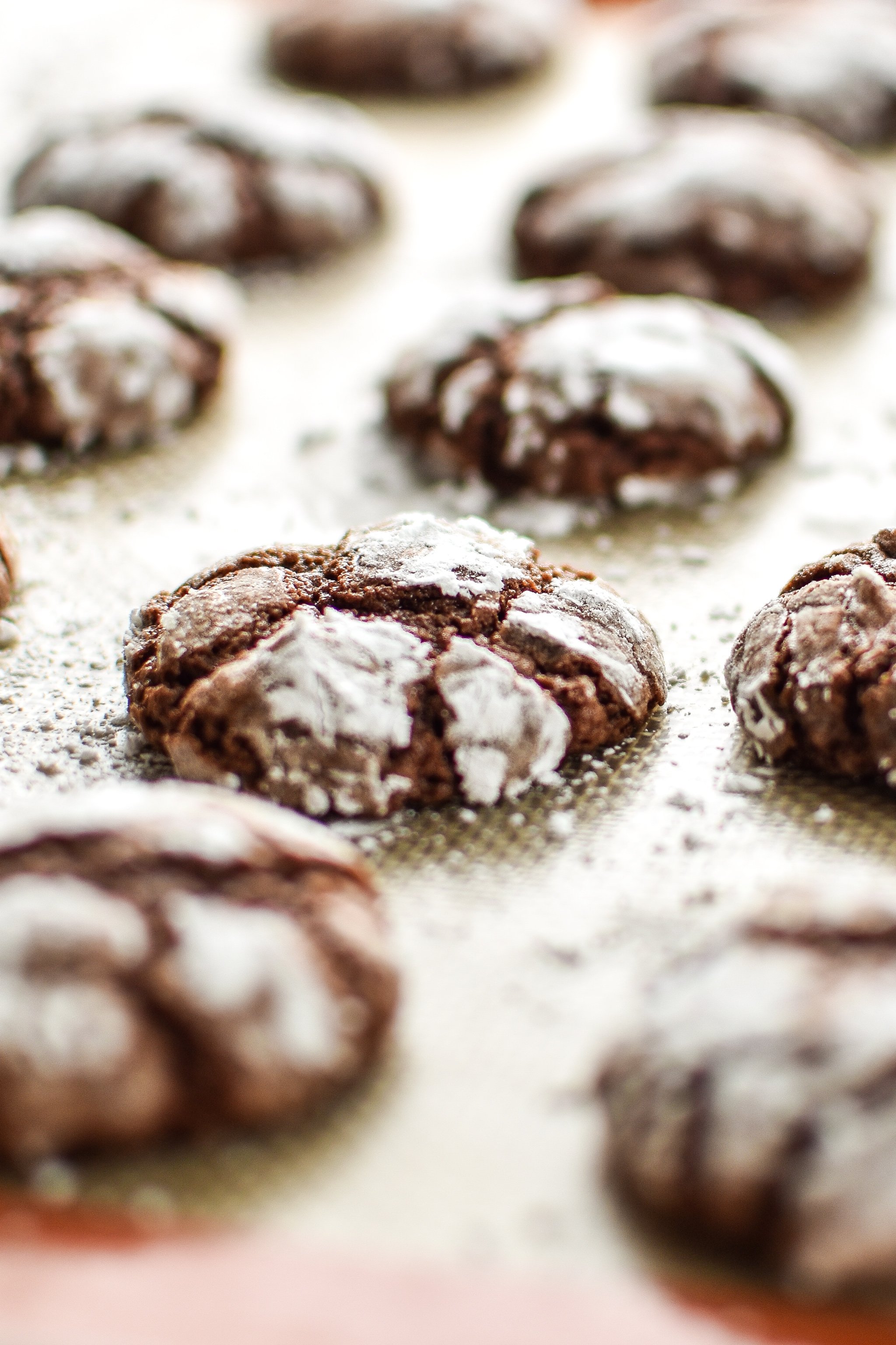 Classic Chewy Chocolate Crinkle Cookies on a silpat baking pan.
