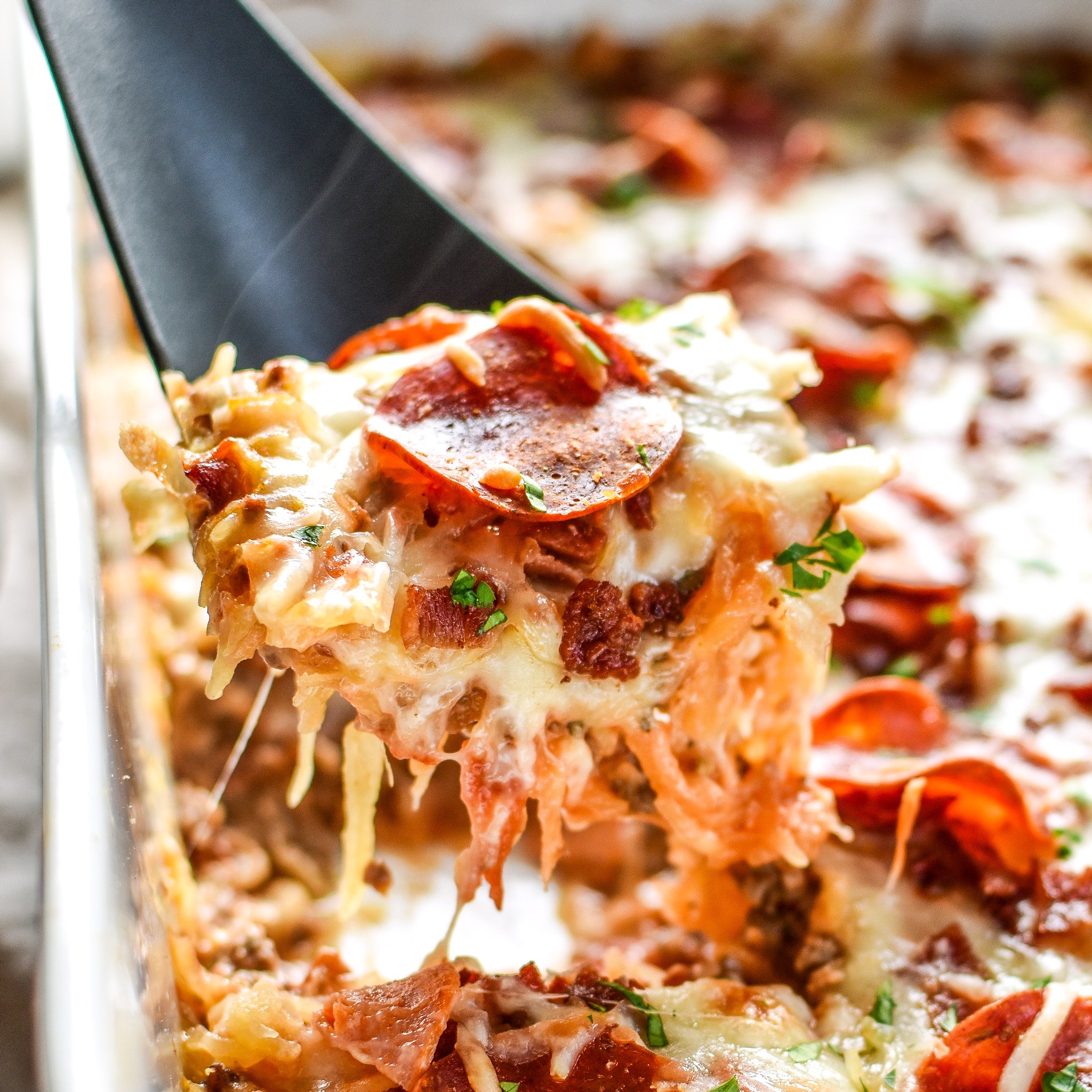 The best shot of Meat Lover's Spaghetti Squash Pizza Casserole - It's pizza, but morphed into a not-that-bad-for-you spaghetti squash casserole with meat lover's toppings! - ProjectMealPlan.com