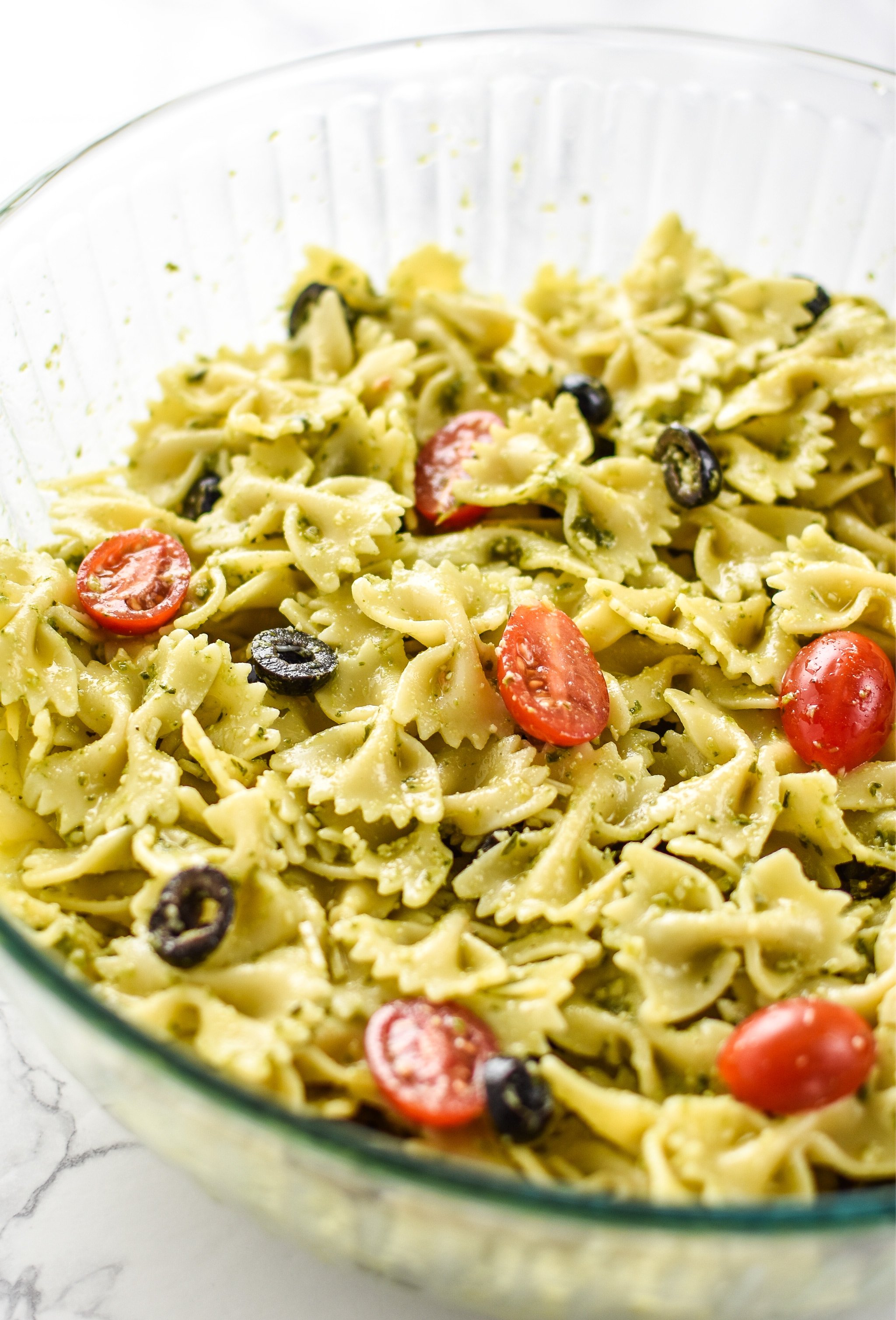 A big delicious bowl of Incredibly Easy Pesto Pasta Salad - just 6 simple ingredients for the best make-ahead side dish! - ProjectMealPlan.com