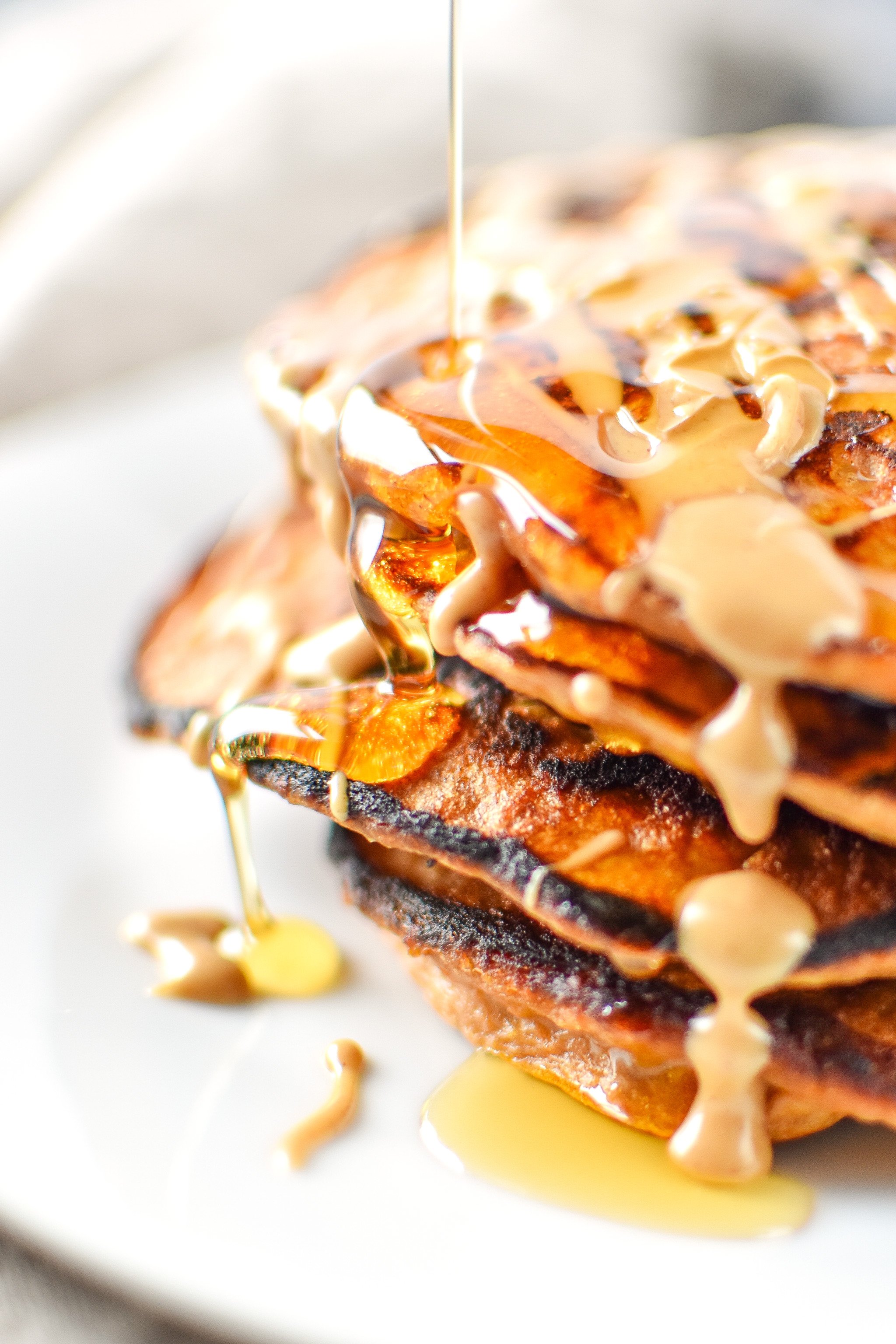5-Ingredient Sweet Potato Banana Pancakes - Banana, sweet potato, nut butter, eggs and cinnamon are all you need to make these simple pancakes happen. Maple syrup drizzled on top is the best!