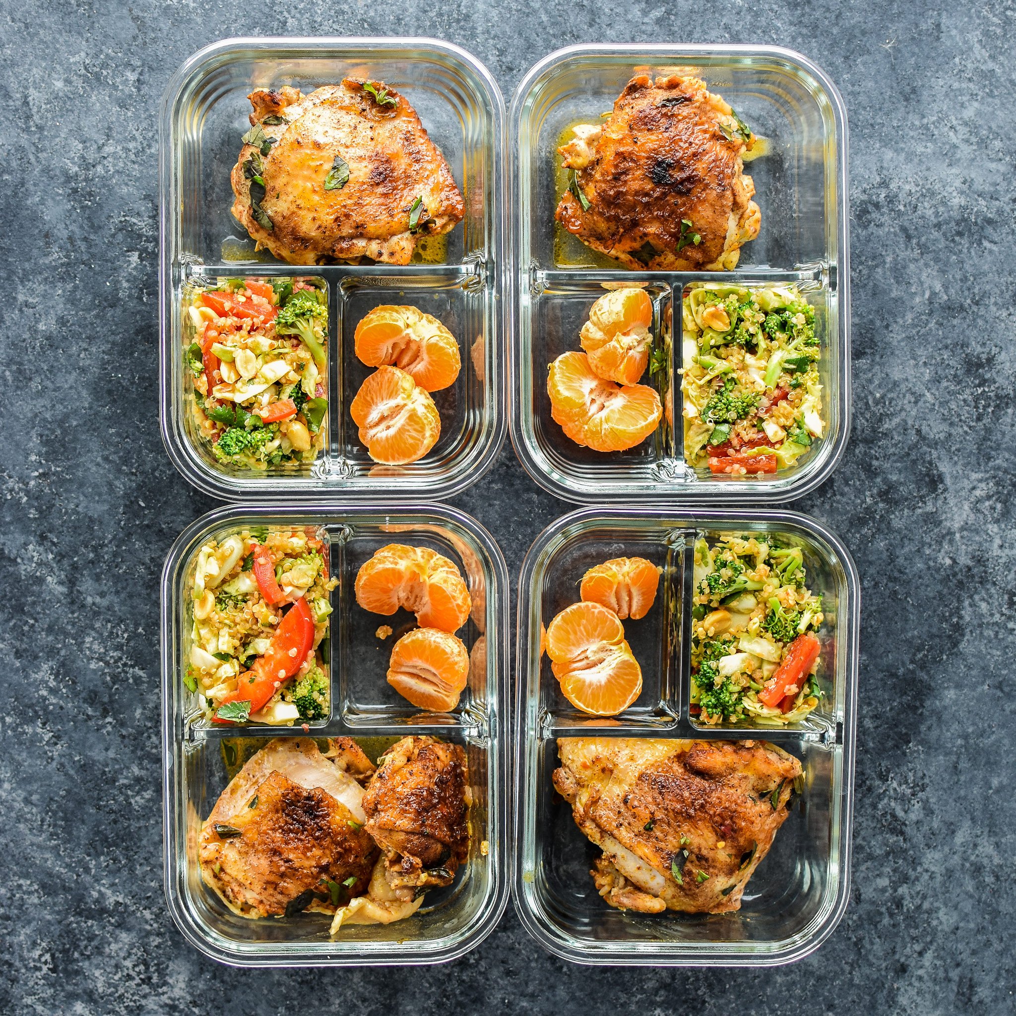 Meal prepped chicken thighs with asian quinoa salad and mandarins.