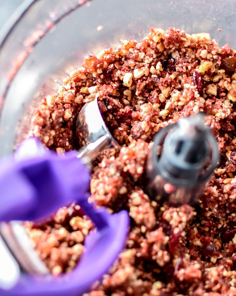 date nut mixture in a food processor bowl for the spiced berry bliss balls.