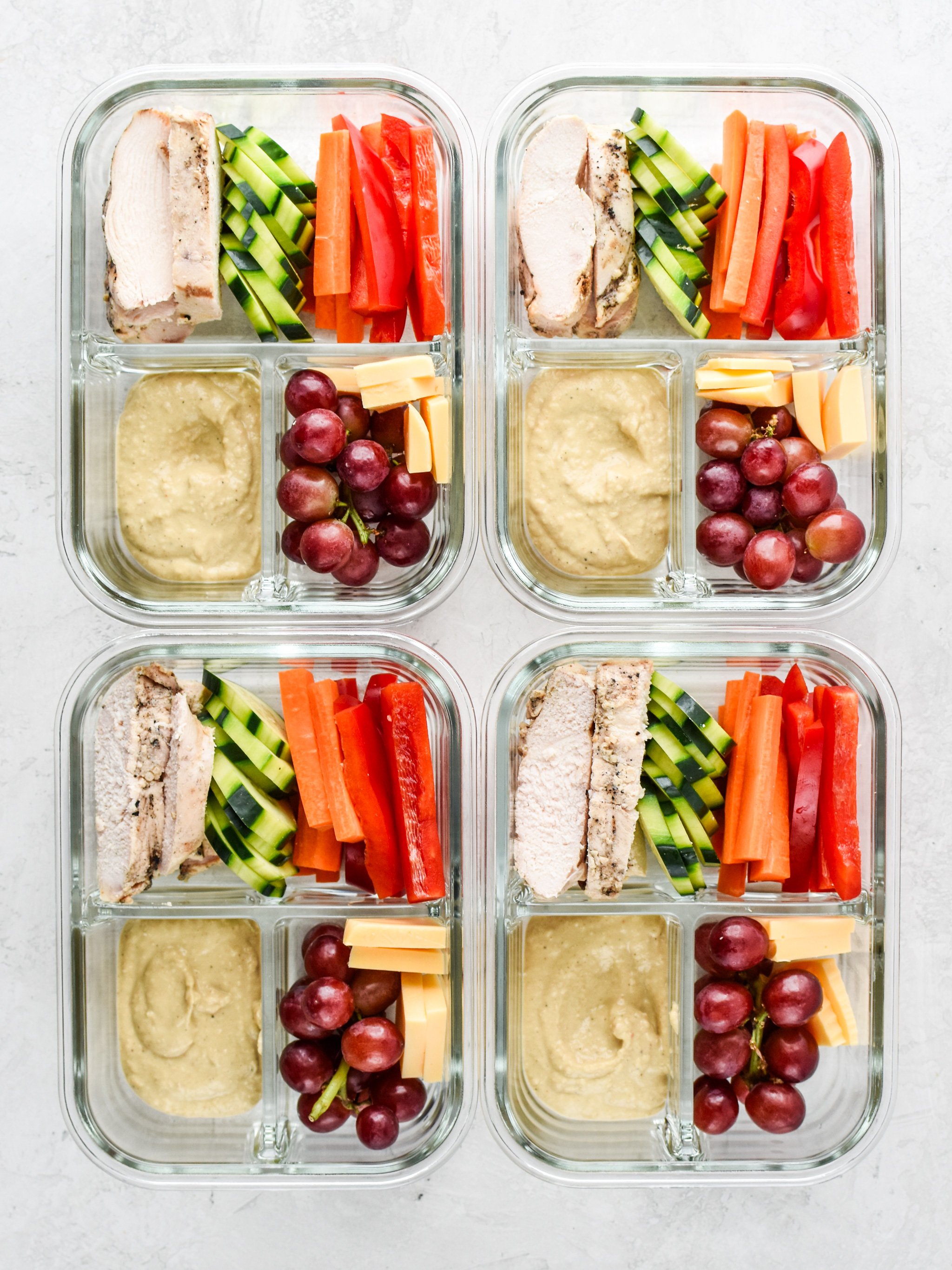 Chicken & Hummus Plate Lunch Meal Prep lunches with chicken, vegetables and hummus.