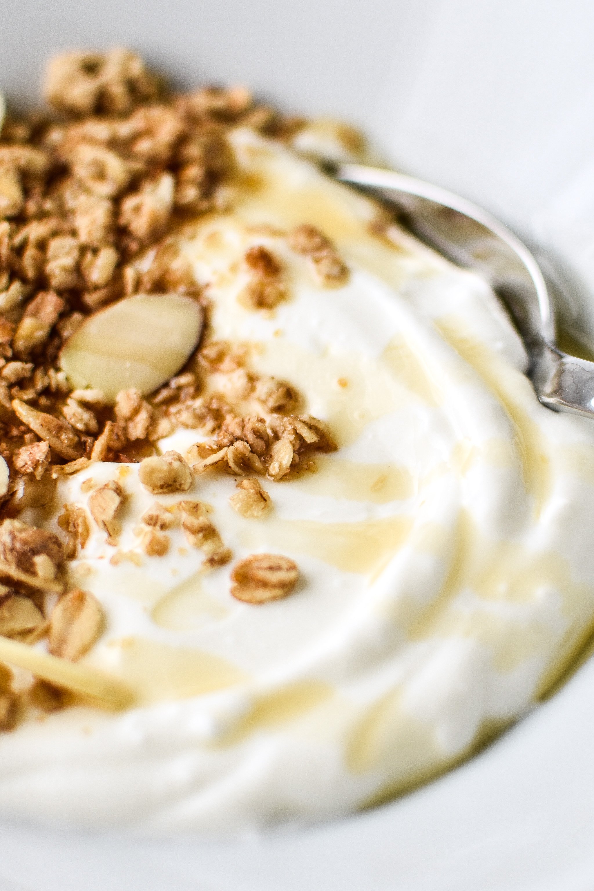 Freshly made yogurt with granola and a light maple syrup drizzle.
