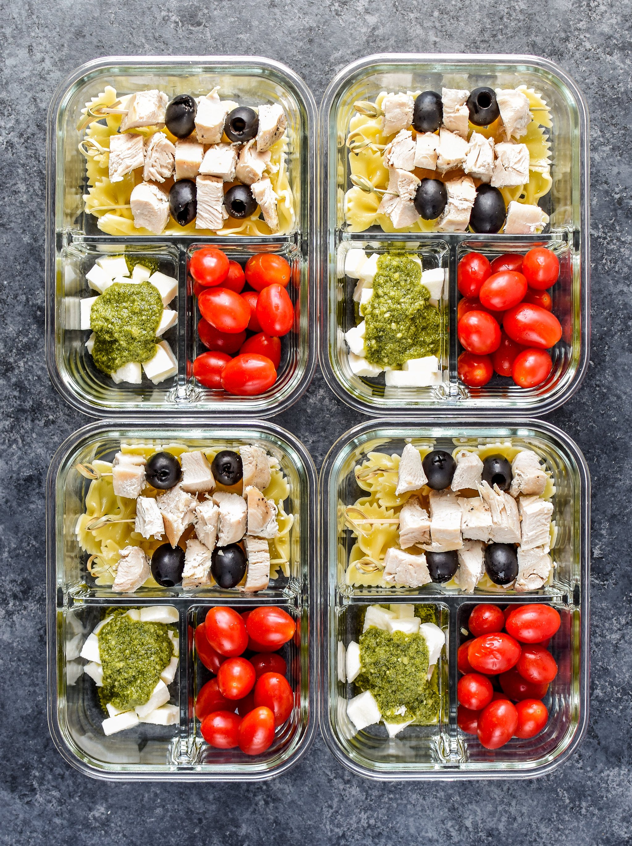 DIY Chicken Pesto Pasta Skewers Meal Prep with fresh mozz, grape tomatoes, bowtie pasta and chicken breast.