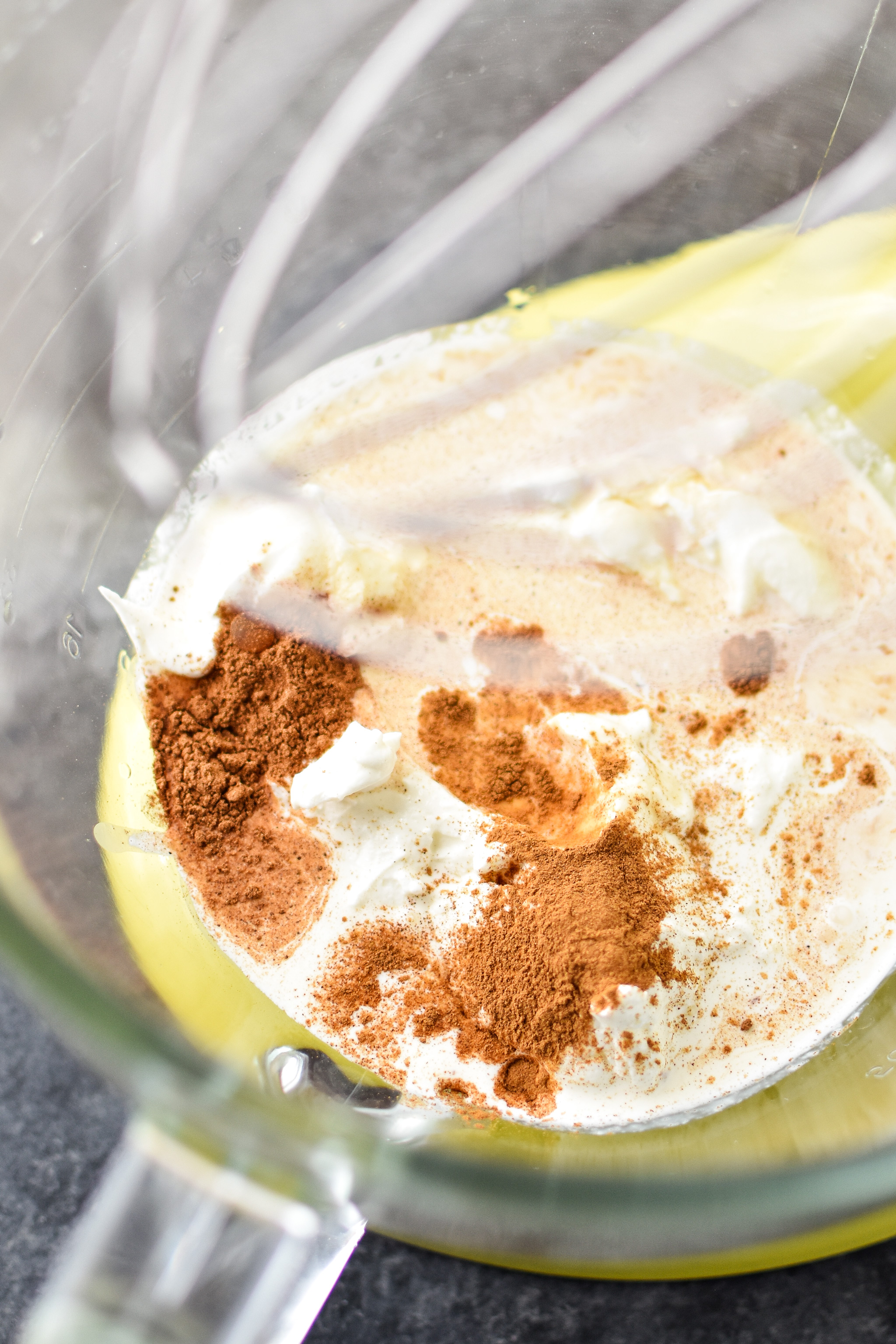 The ingredients for pumpkin whipped greek yogurt in the mixing bowl.