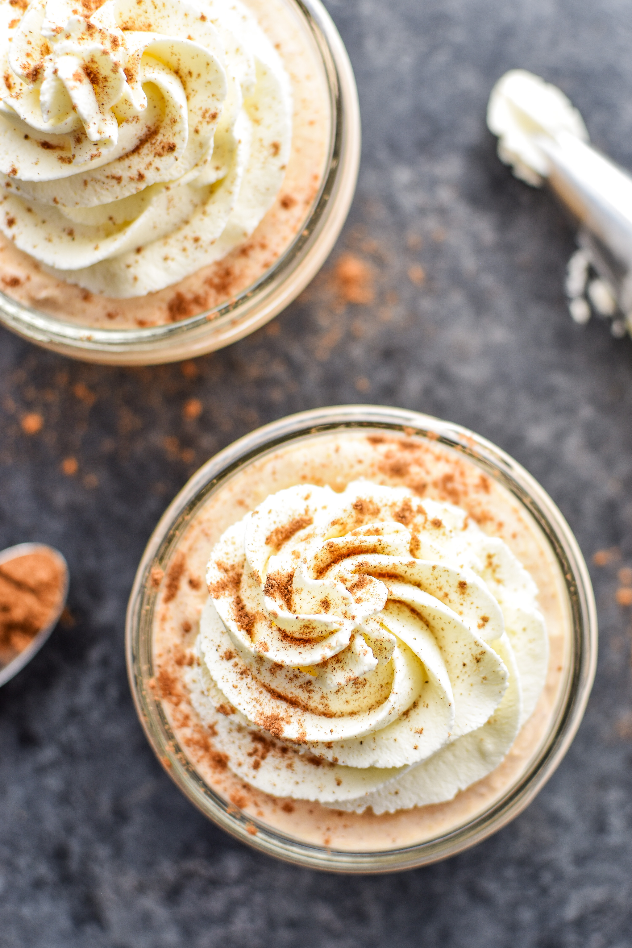 Top view of two bowls of pumpkin spiced whipped greek yogurt. 