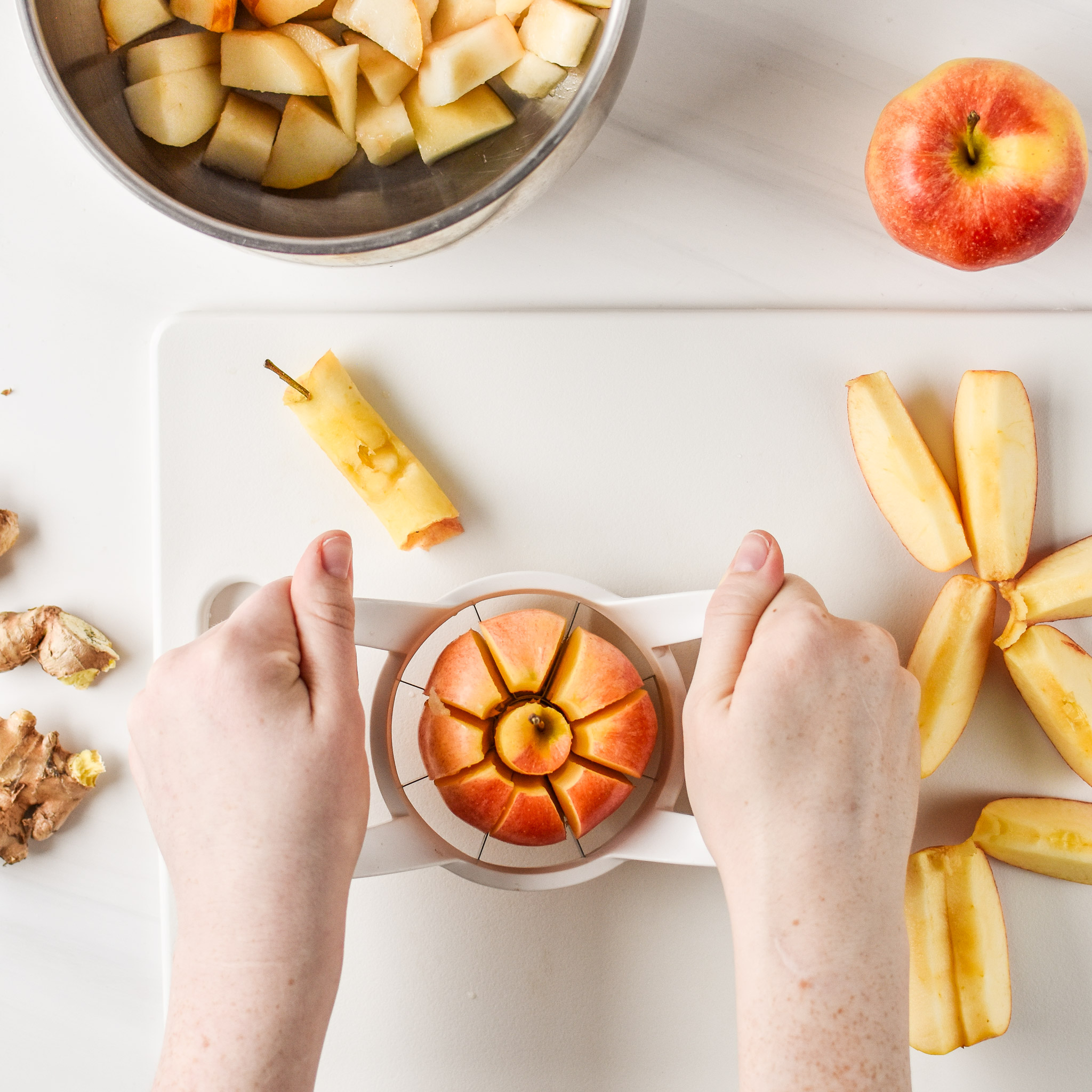 Using an apple slicer to cut apples for the Ginger Pear Cinnamon Applesauce