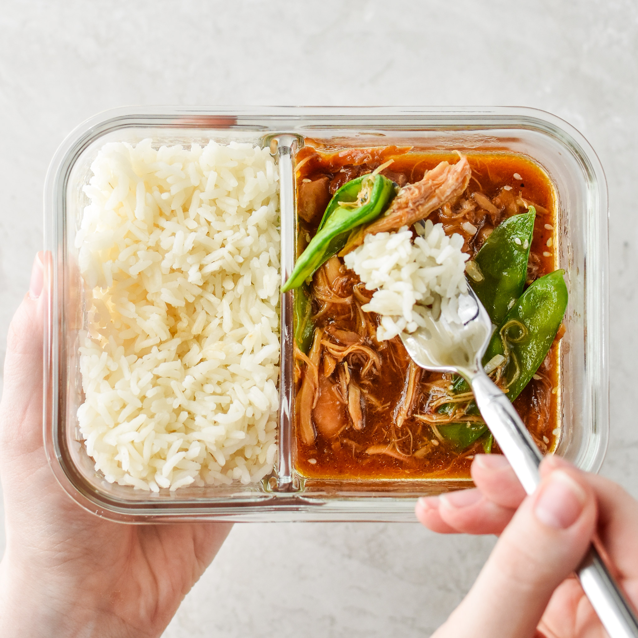 Holding a bowls of the Instant Pot Honey Garlic Chicken Meal Prep Bowls.