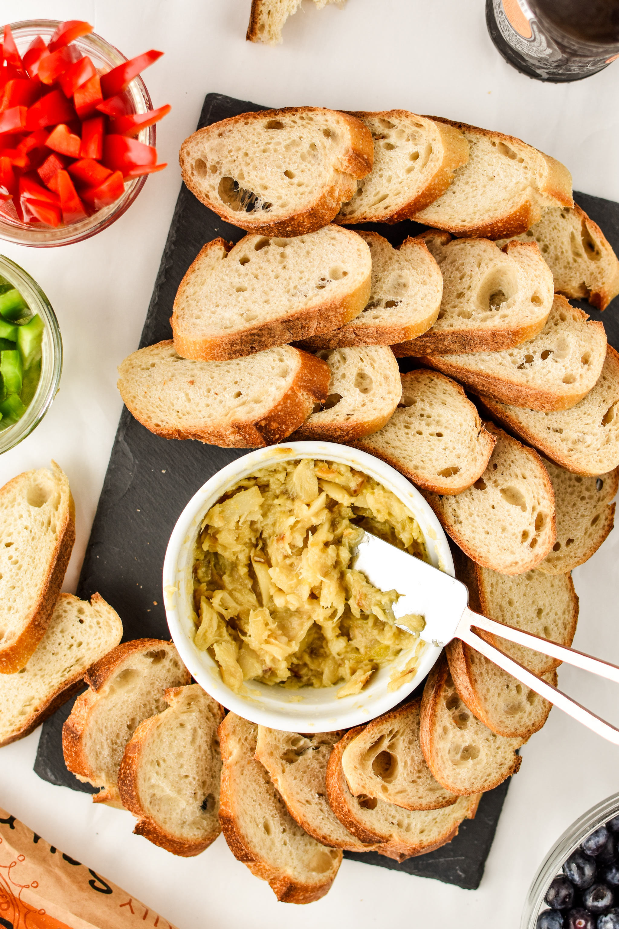 A spread of sourdough bread with roasted garlic to spread on top