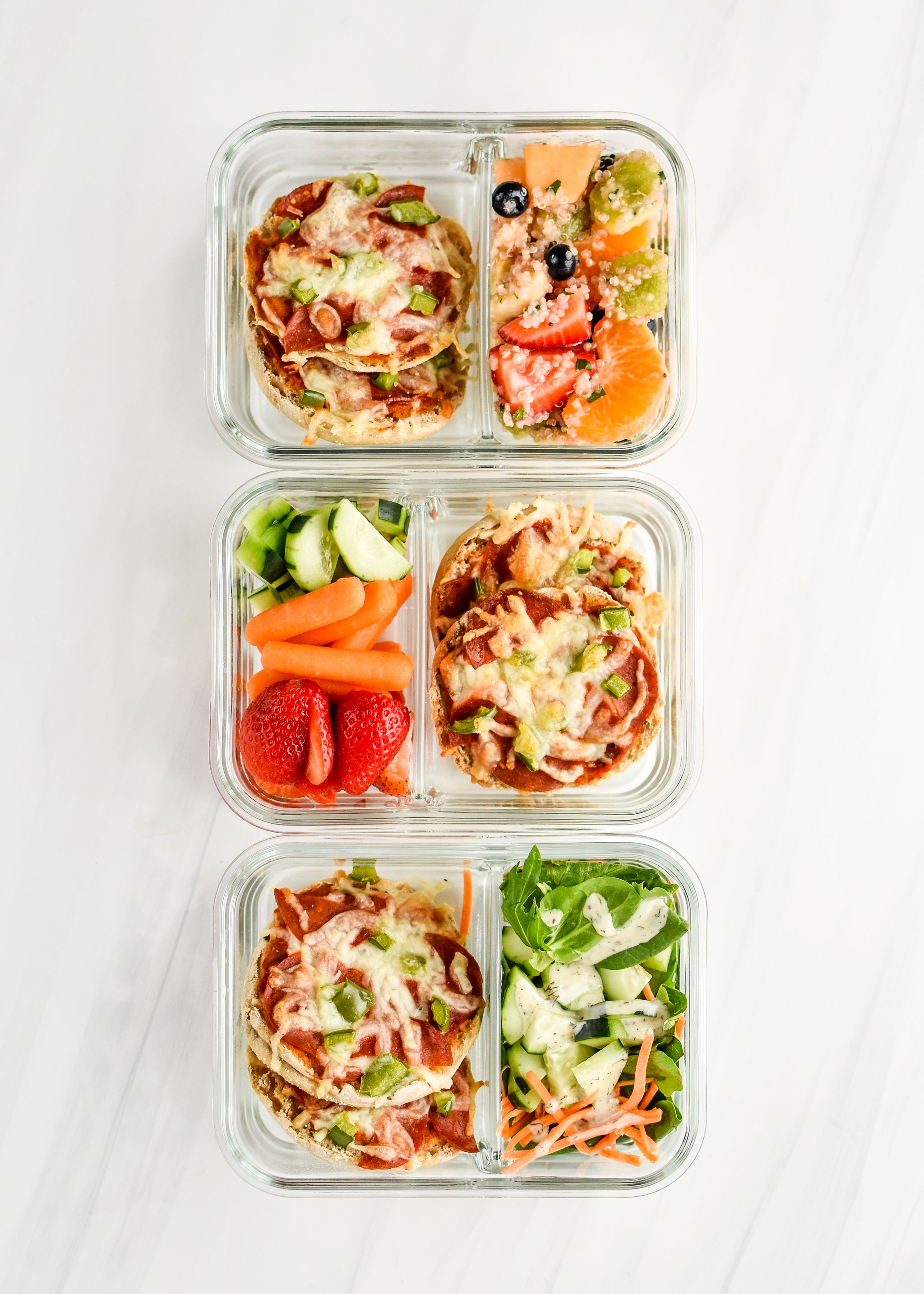 English muffin mini pizzas pictured in meal prep containers with fresh produce or salads.