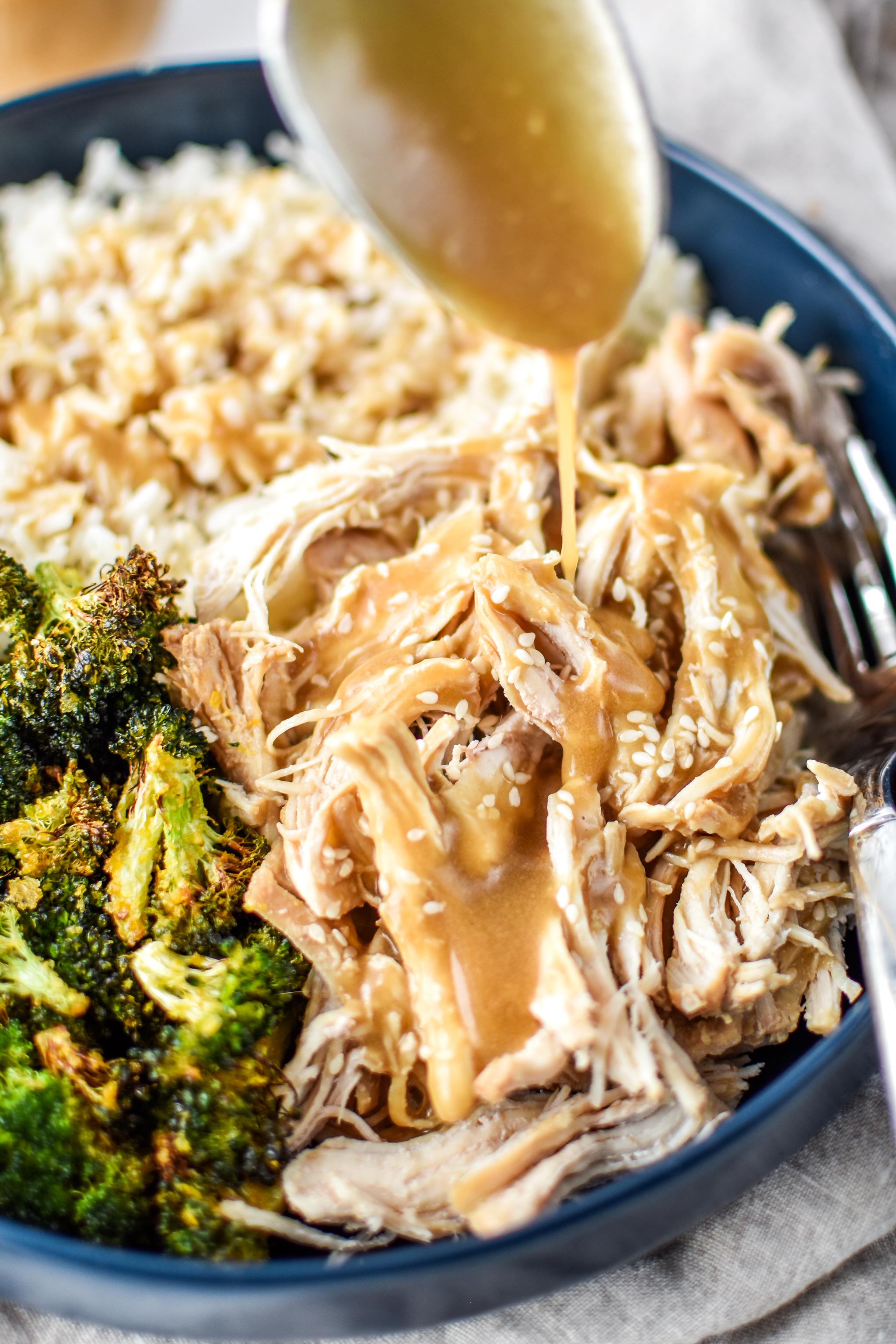 Eating sesame shredded chicken with rice and broccoli