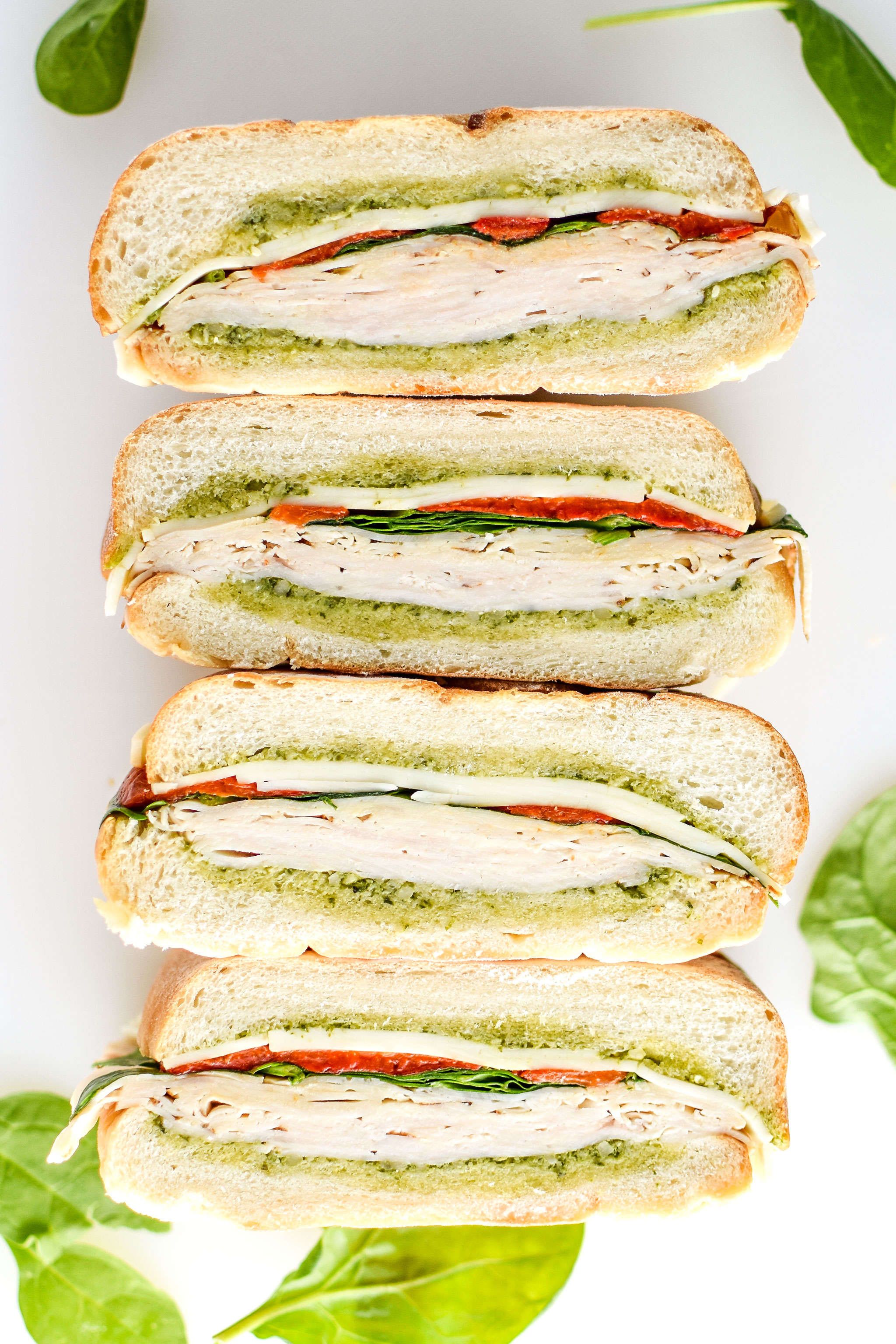 Pesto chicken overnight pressed sandwiches cut into 4 with inside facing up