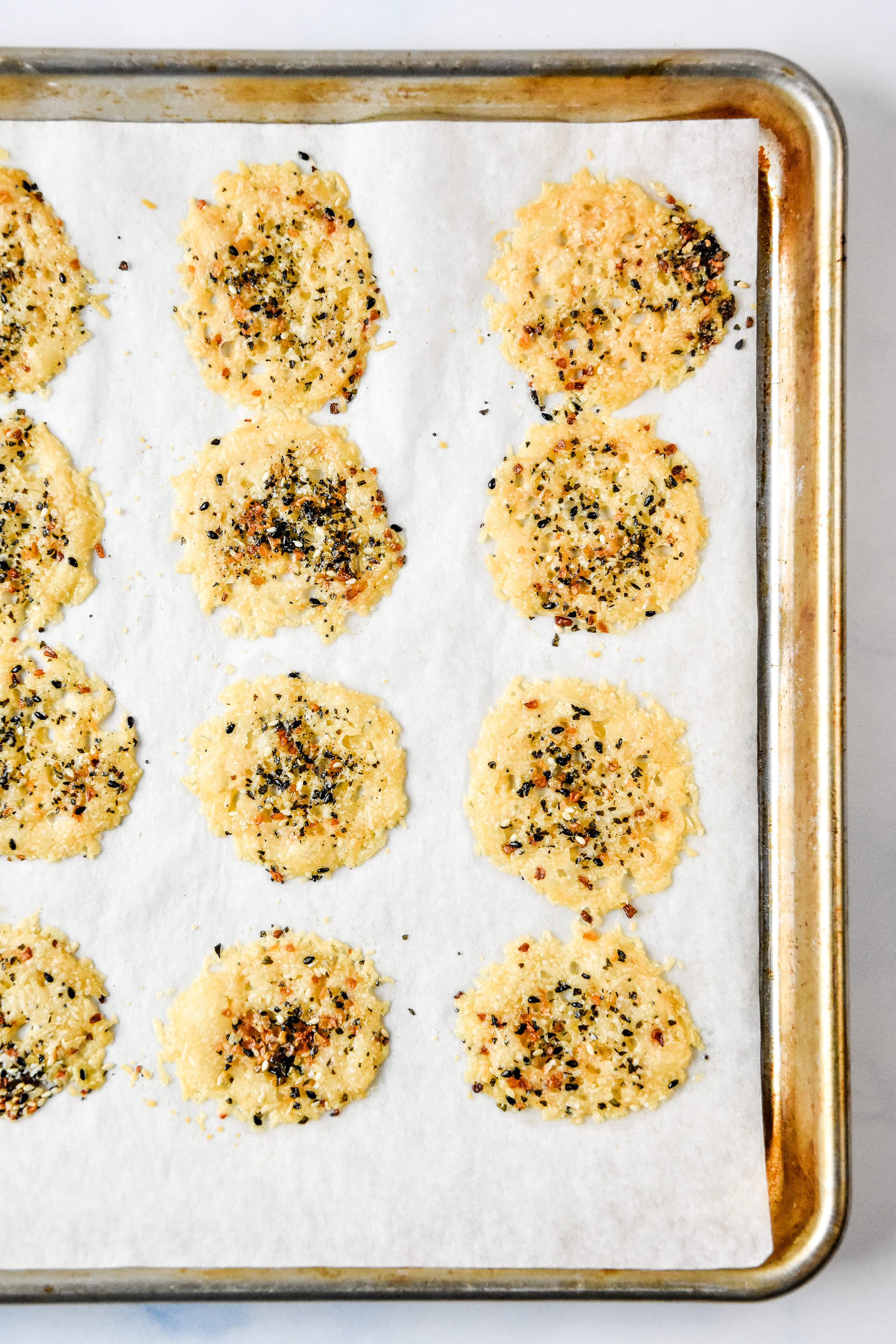 everything bagel baked parmesan cheese crisps fresh from the oven on a baking sheet