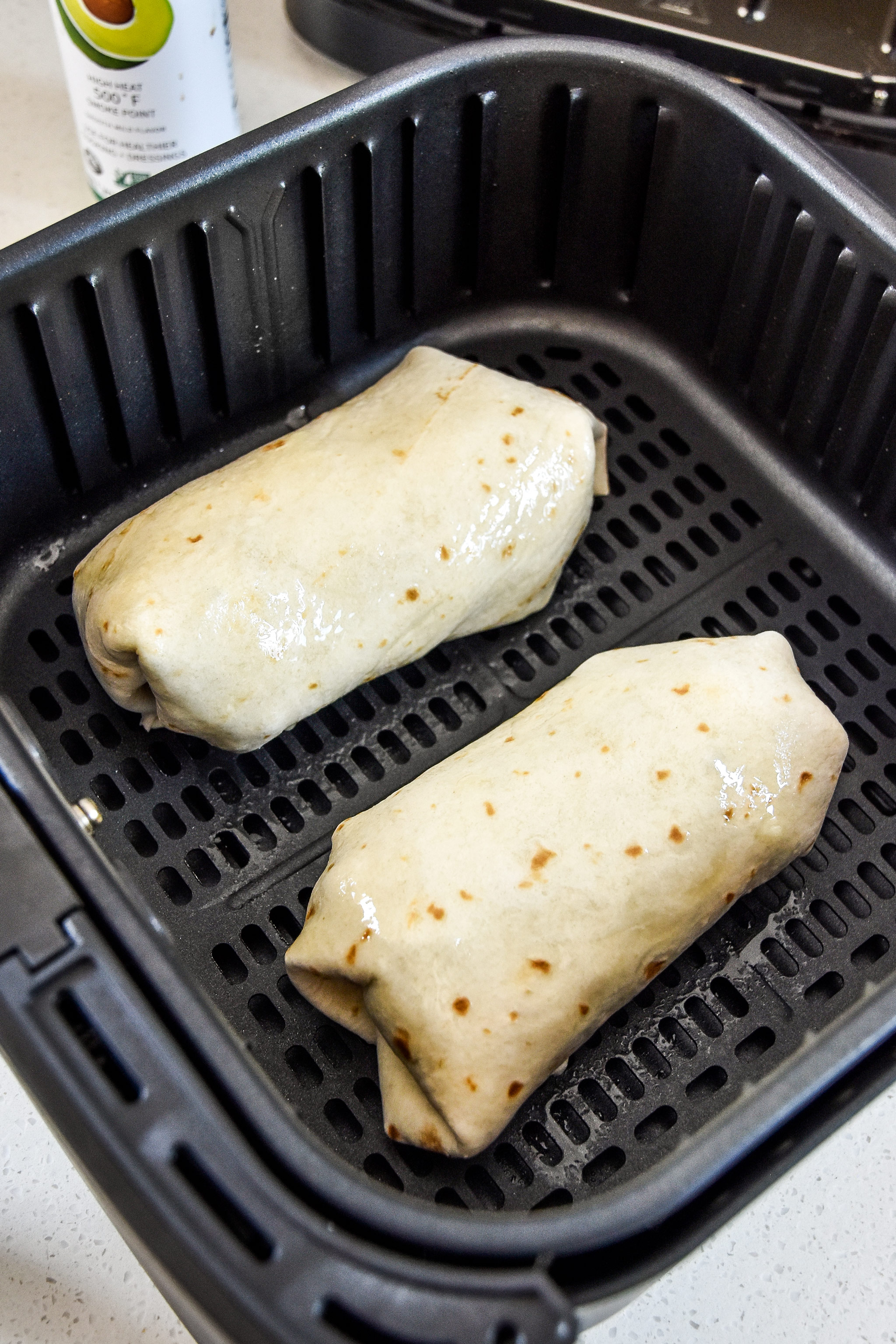wrapped burritos about to be cooked in the air fryer