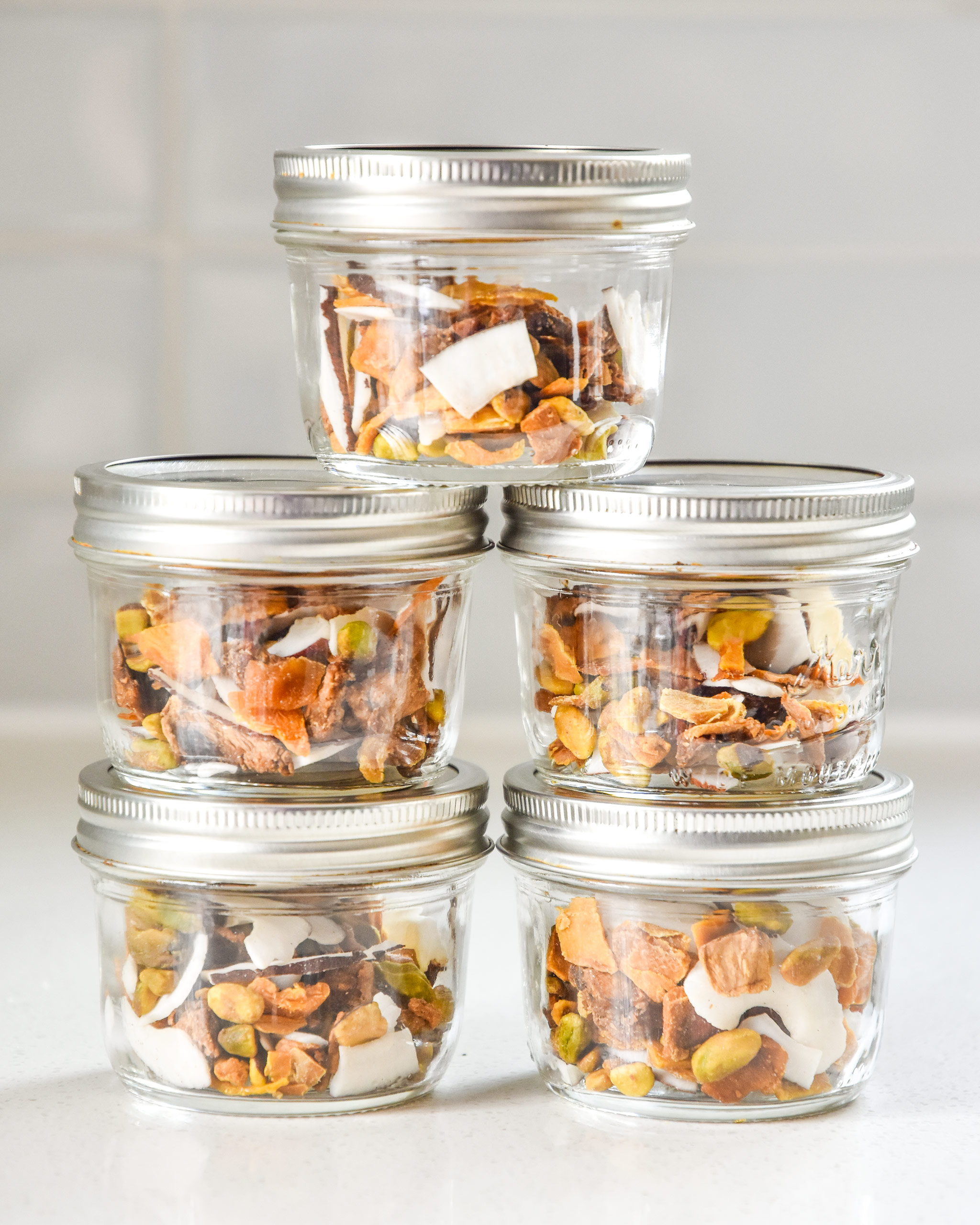 tropical dried fruit trail mix in stacked mason jars