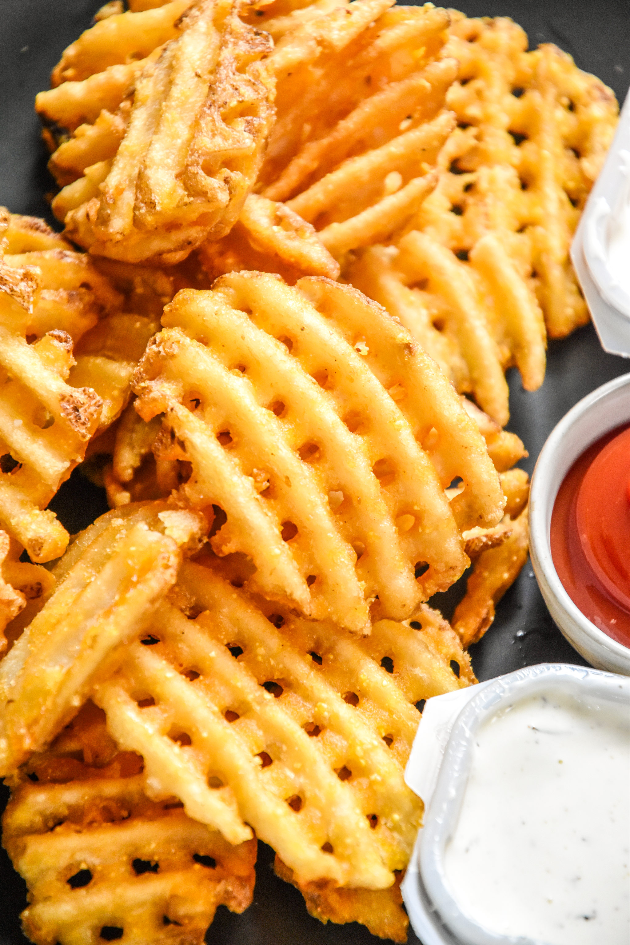 close up of waffle fries reheated in an air fryer