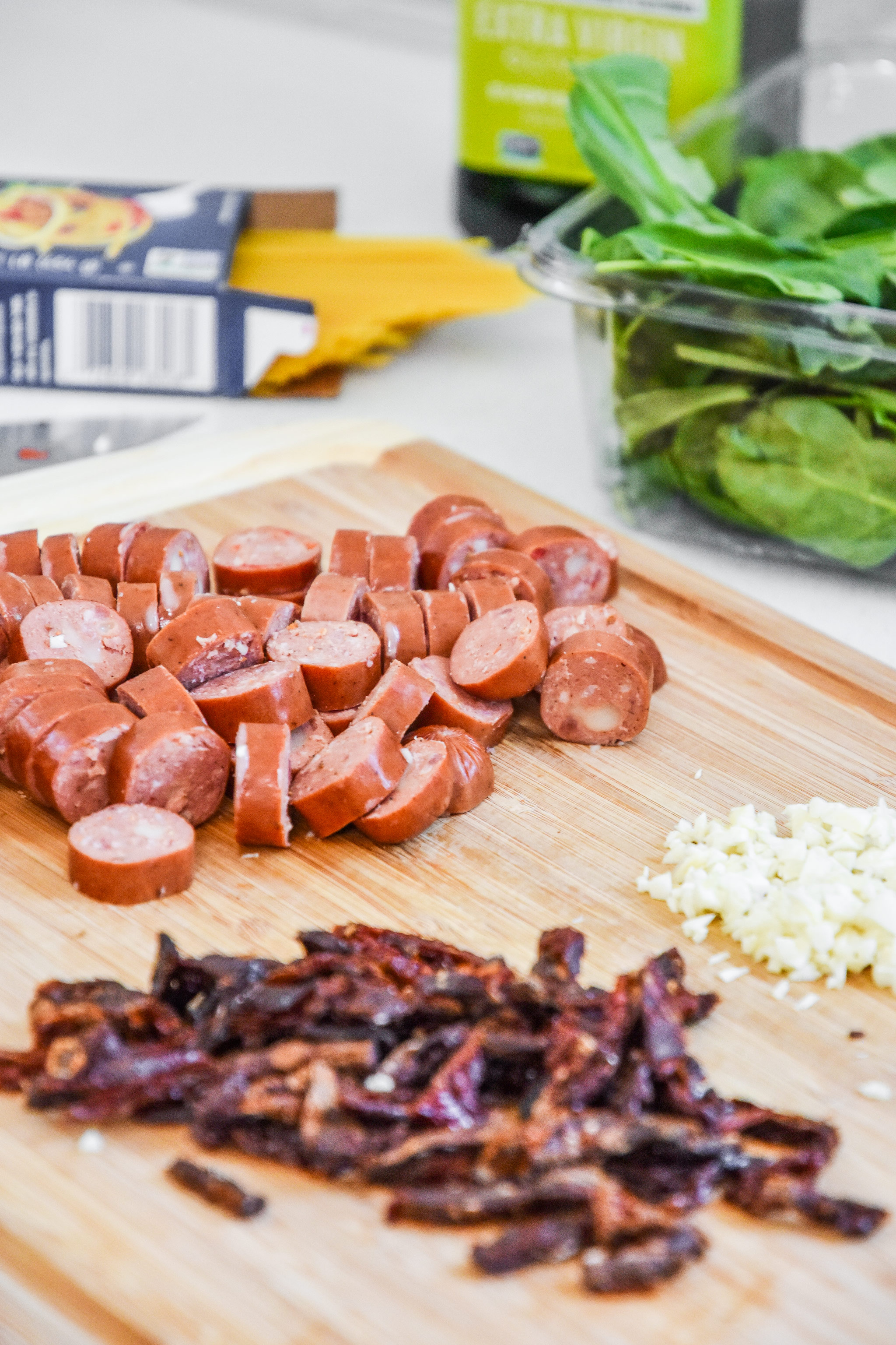 ingredients on a cutting board for the one pot italian sausage pasta