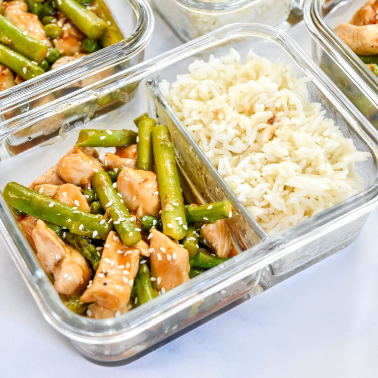 meal prep spicy chicken and asparagus in glass meal prep containers