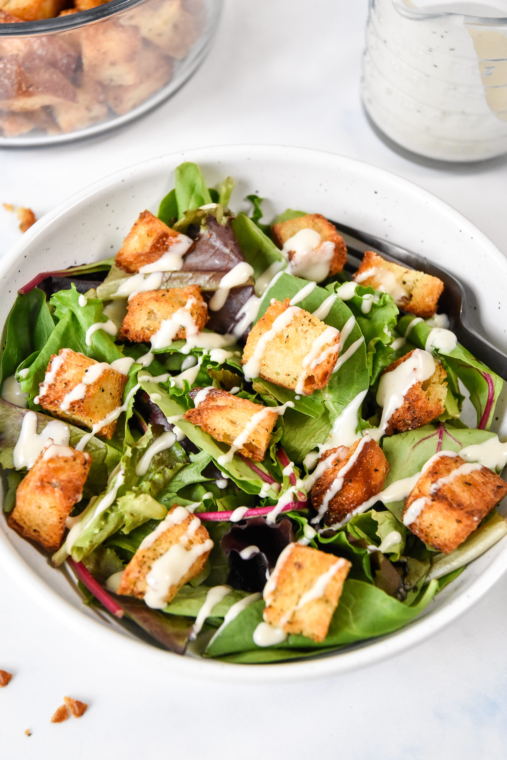 homemade croutons in a salad with ranch drizzle.