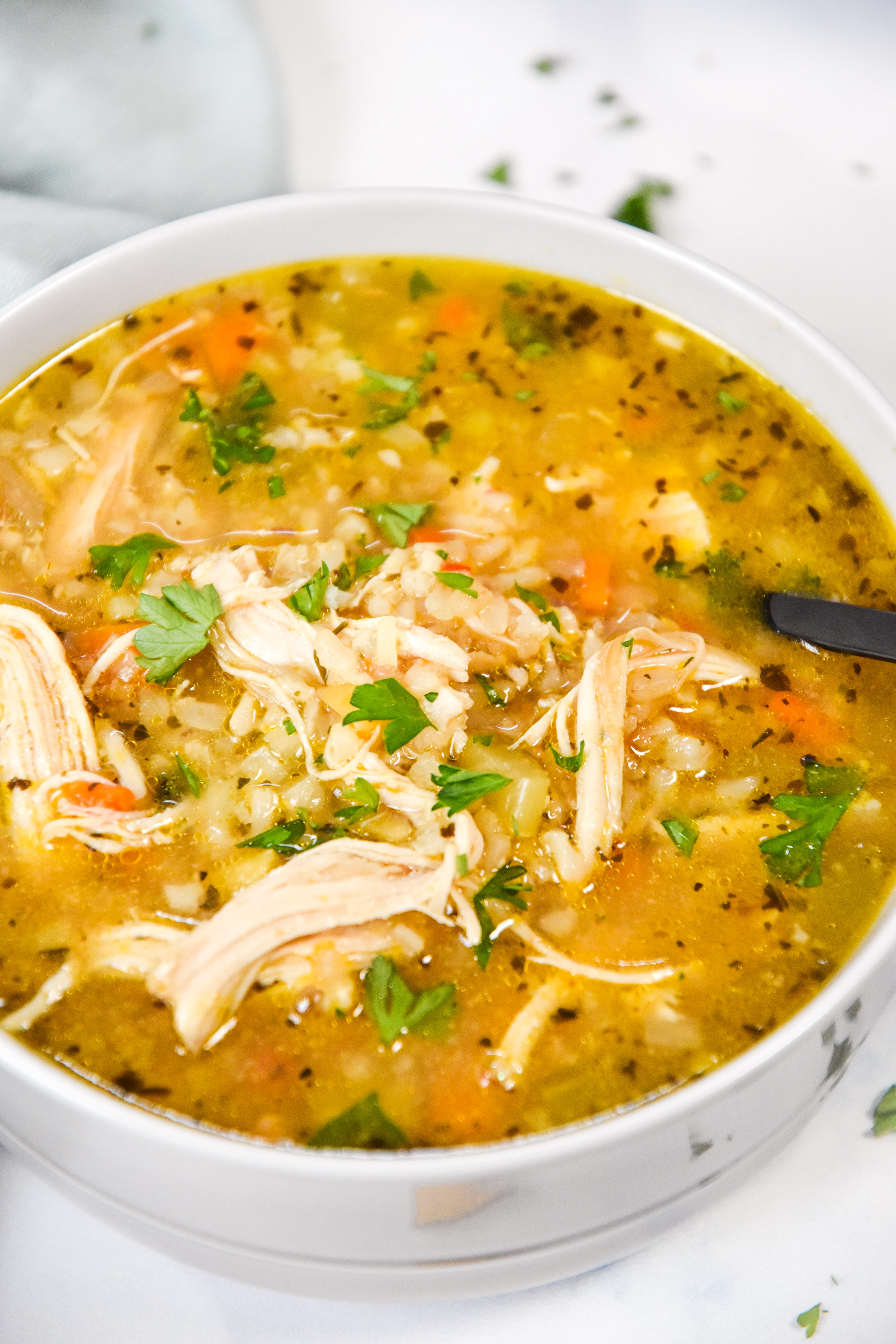 close up bowl of chicken and rice soup.