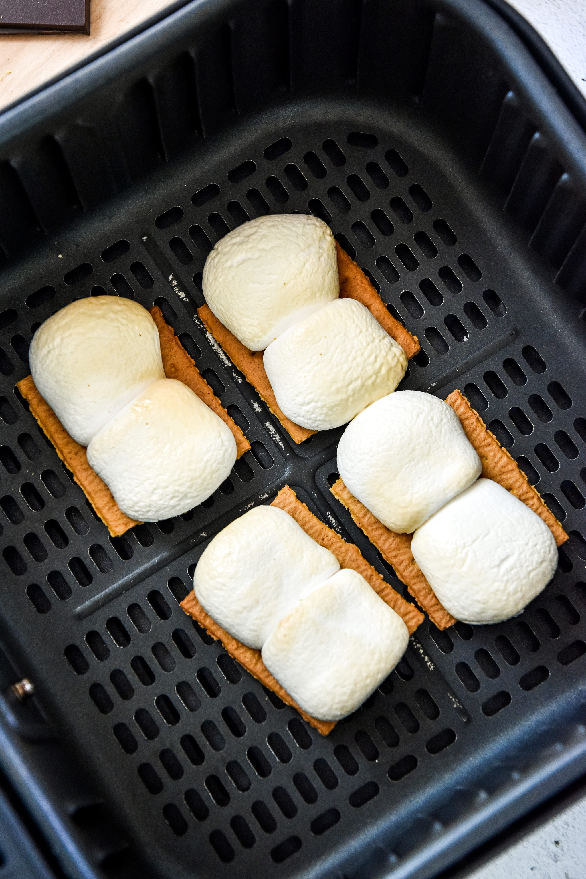 cooked marshmallows in the air fryer basket for s'mores.