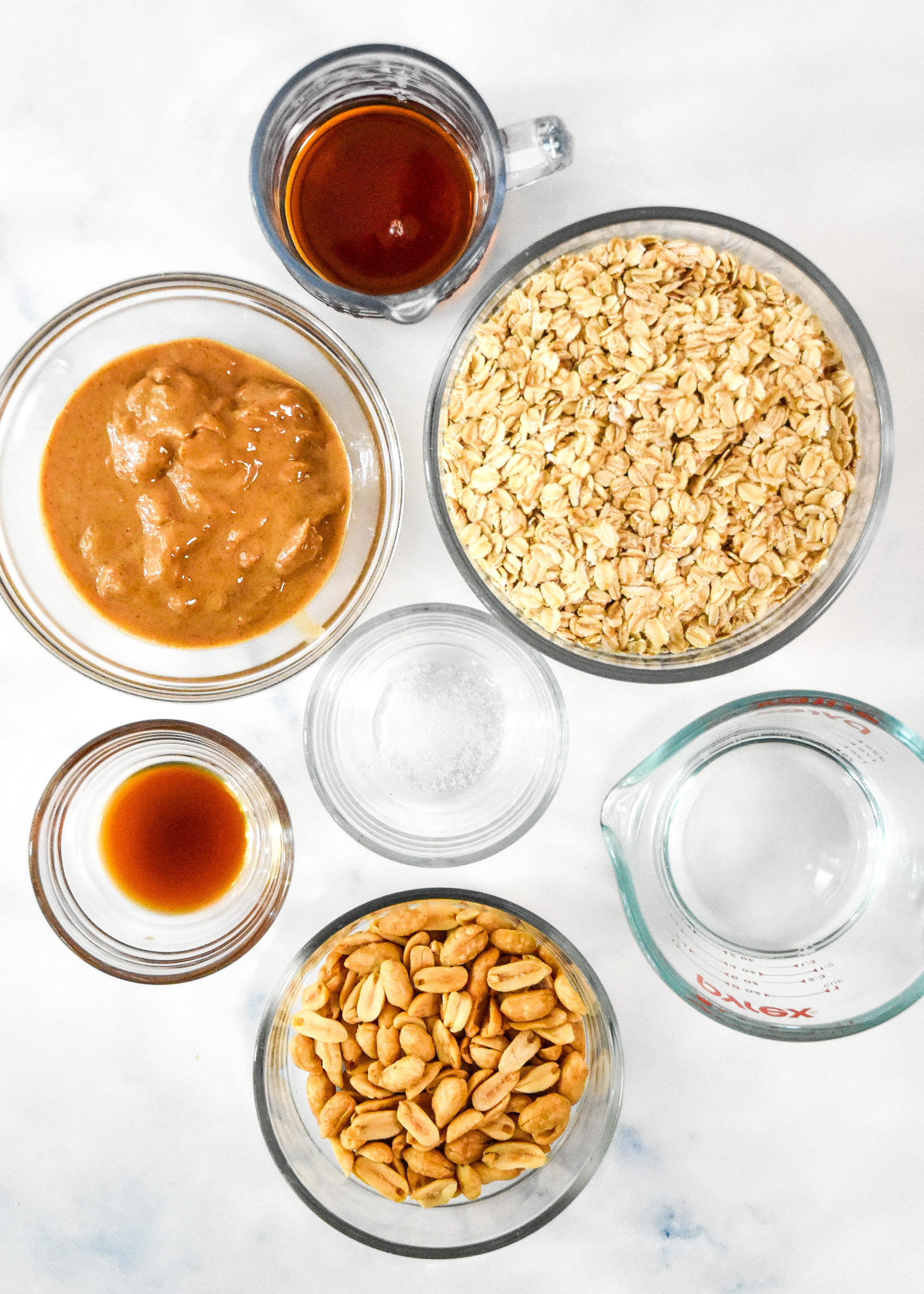 ingredients in glass bowls for the easy peanut butter granola.
