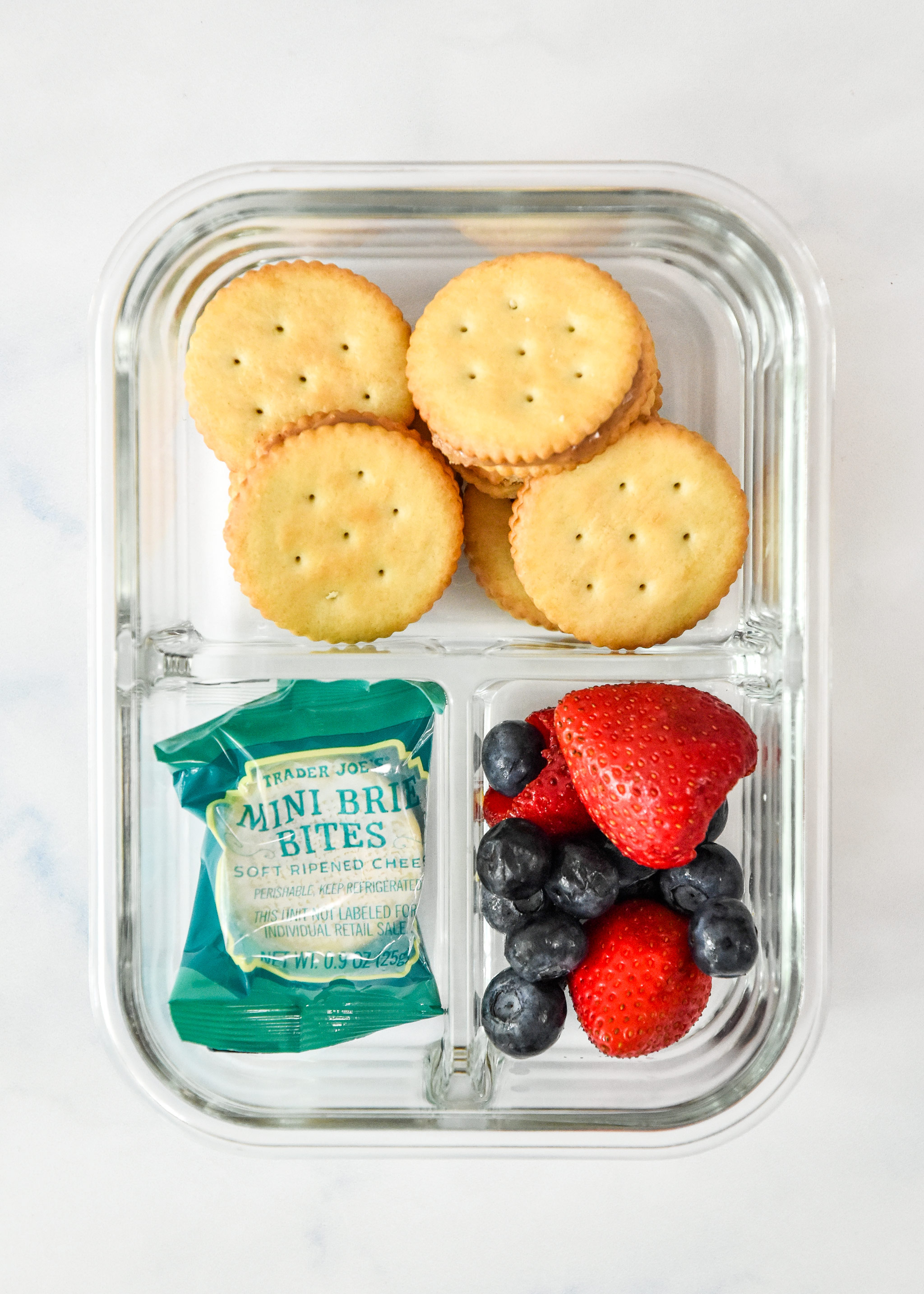 peanut butter cracker sandwiches snack box idea in a meal prep container.