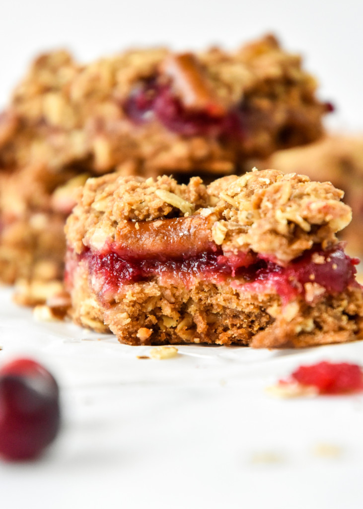 inside view of the cranberry oatmeal crumble bars with a layer of cranberry sauce in the middle.