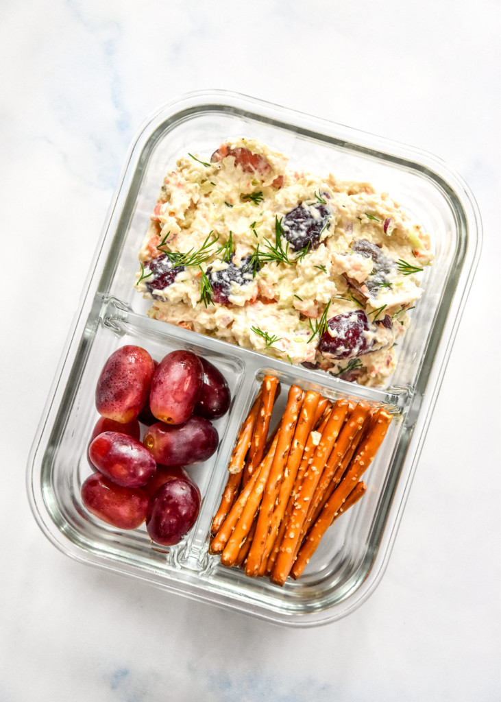 glass meal prep container with easy chicken salad with grapes and pretzels.