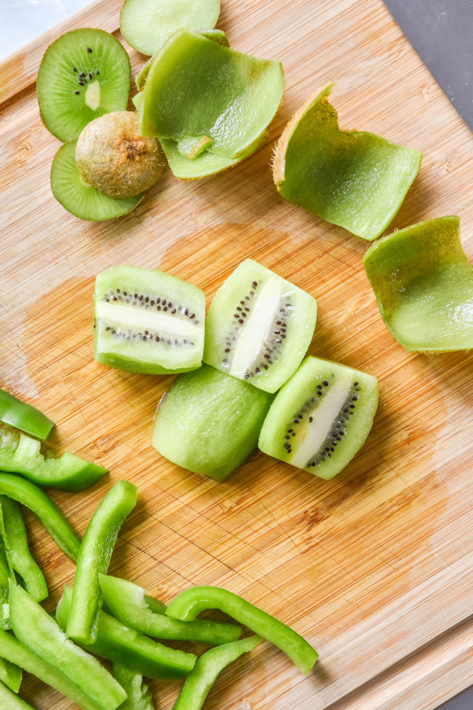 peeled kiwi fruits on a cutting board.