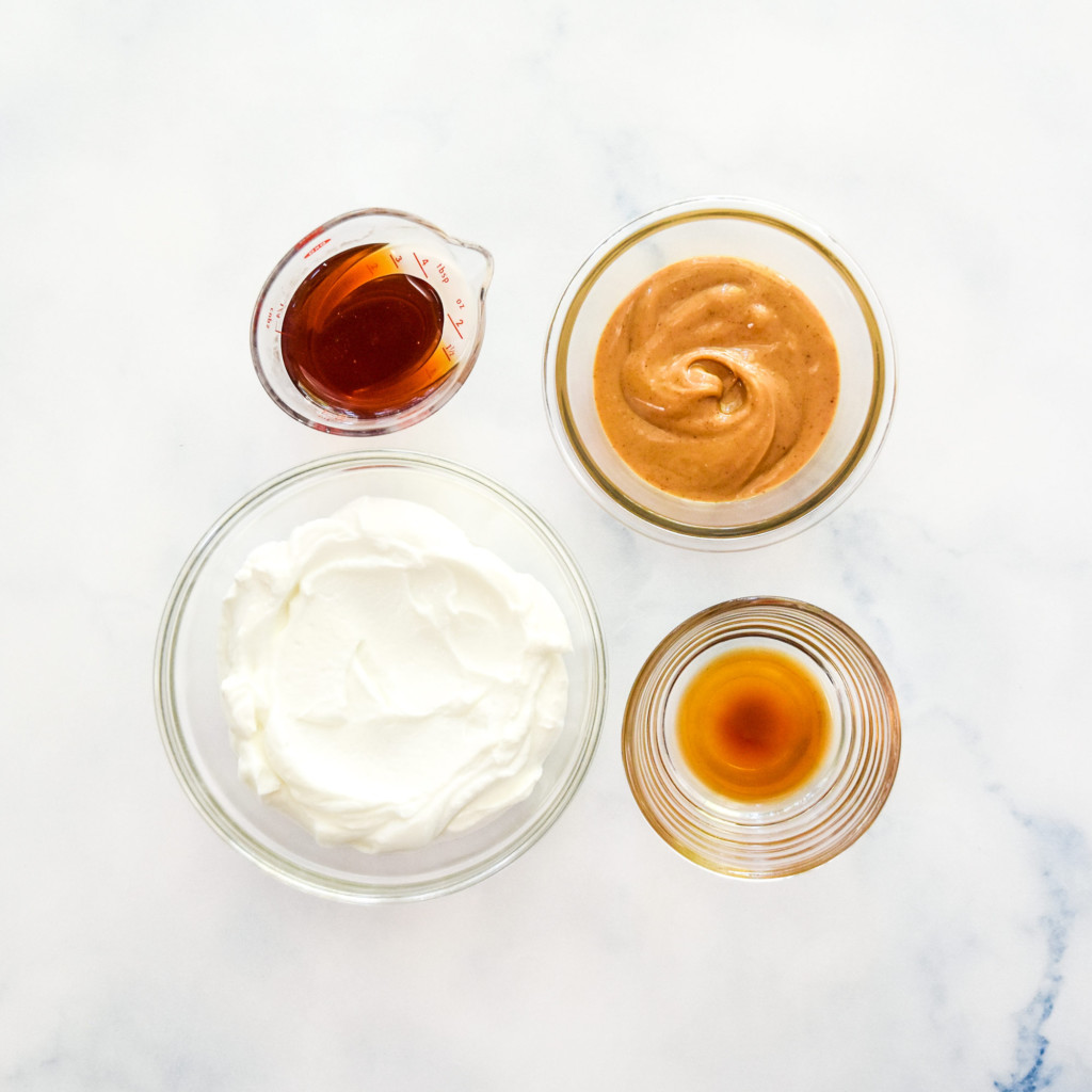 ingredients for peanut butter greek yogurt fruit dip in separate bowls before mixing.