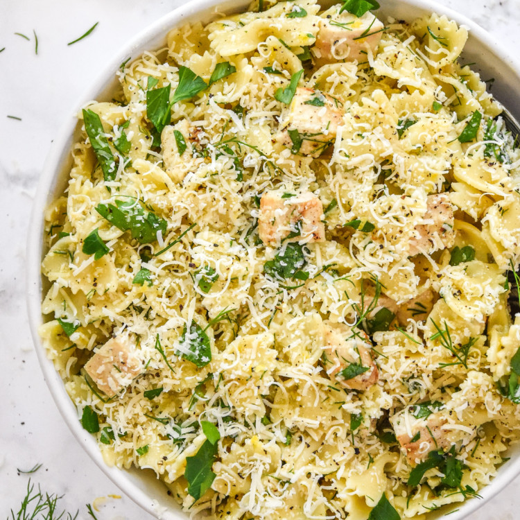 Herby lemon chicken pasta salad in a white bowl.