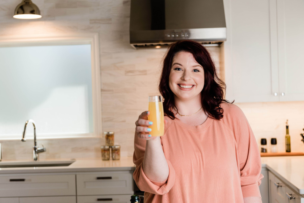 dark haired woman holding glass of champagne.