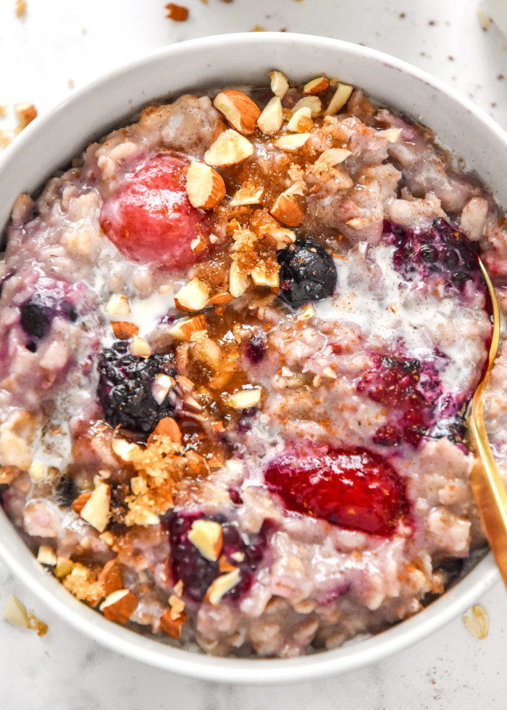 closeup of the stovetop triple berry egg white oatmeal in a bowl with almonds on top.