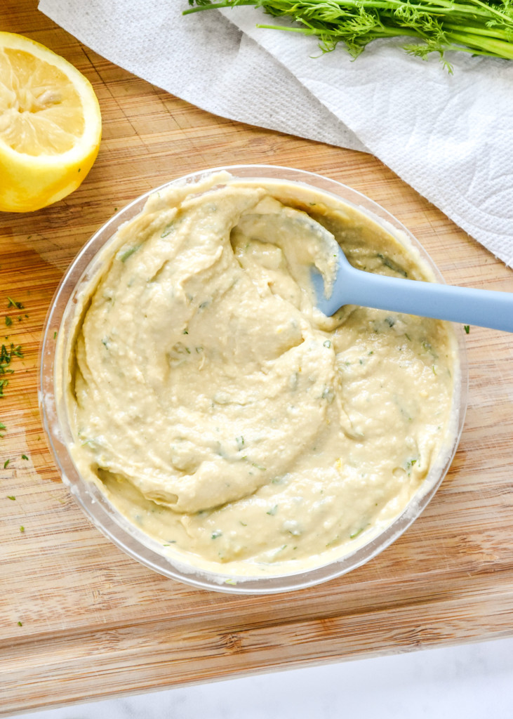 lemon dill hummus stirred up in a store bought container to add to grain bowls.