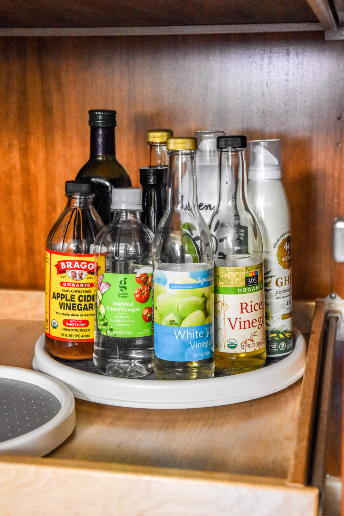 lazy susan in a pantry with vinegars on it.