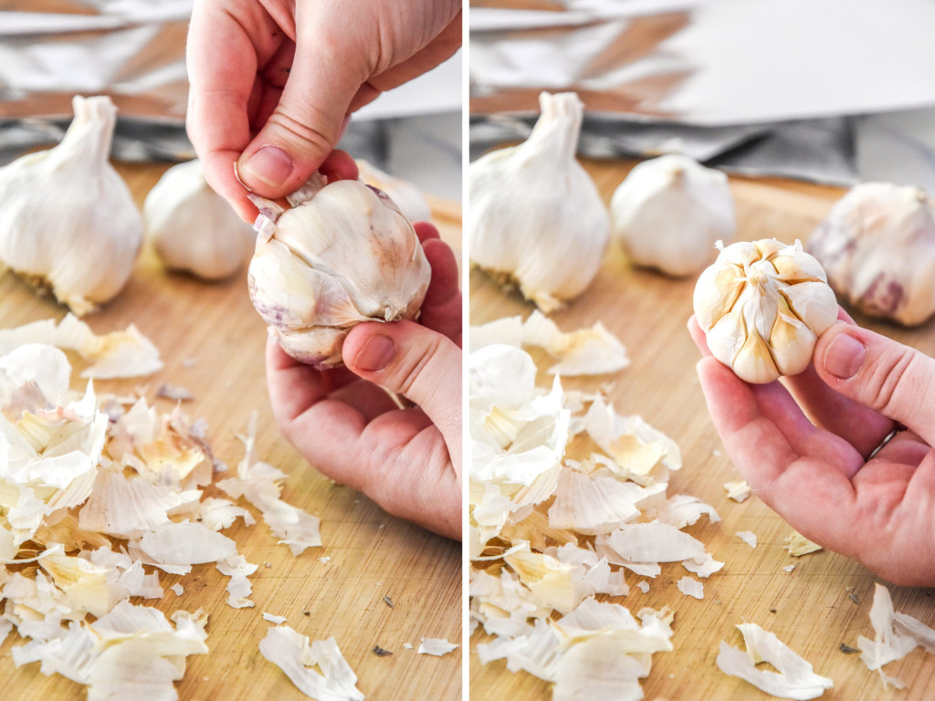 peeling the outer skins from a head of garlic.