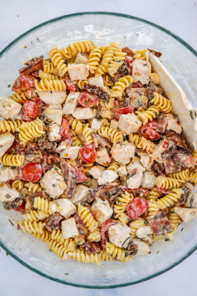 mixed up make-ahead chicken club pasta salad in a large bowl.
