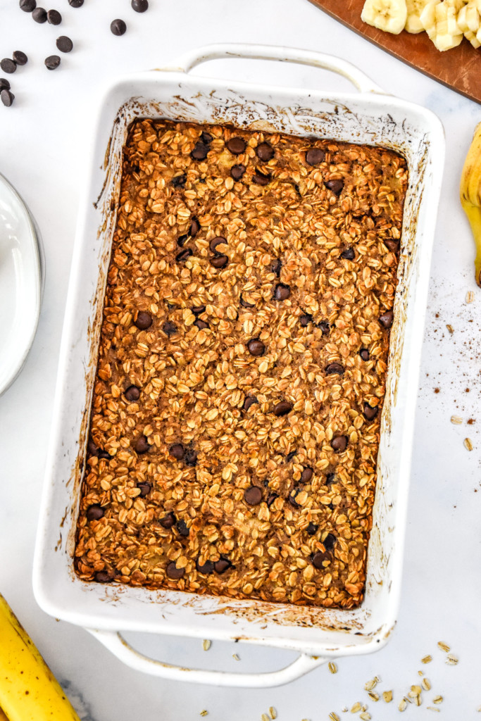 fresh baked chocolate chip banana bread baked oatmeal in a white casserole dish.