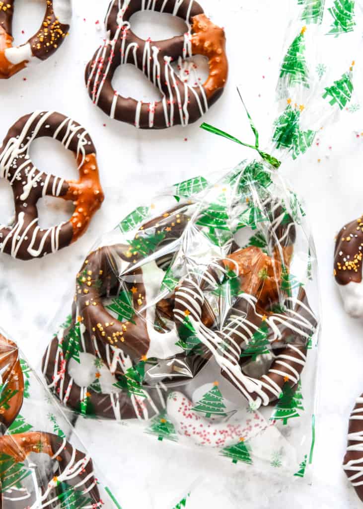 homemade chocolate dipped pretzels in a holiday treat bag.