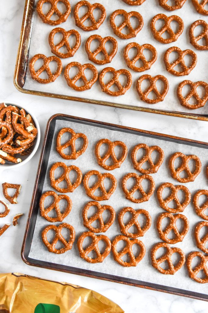 plain pretzels laid out on rimmed baking sheets.