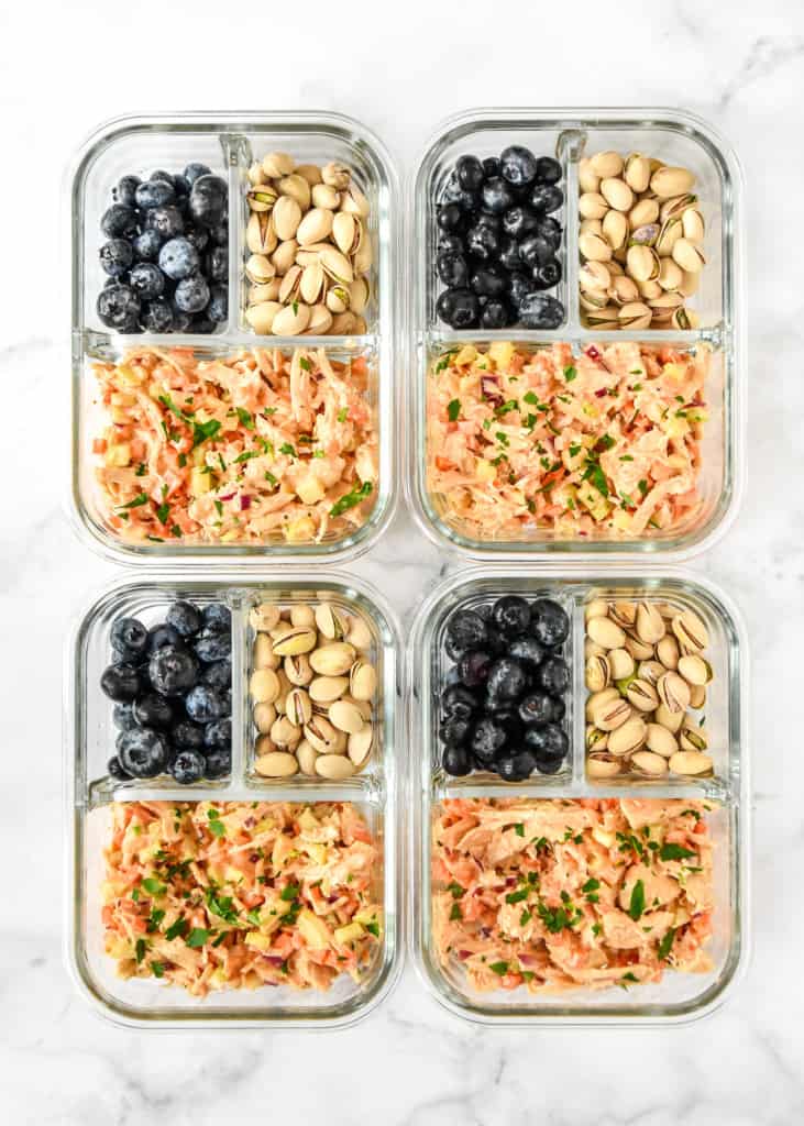 easy buffalo chicken salad meal prep in glass containers with compartments.
