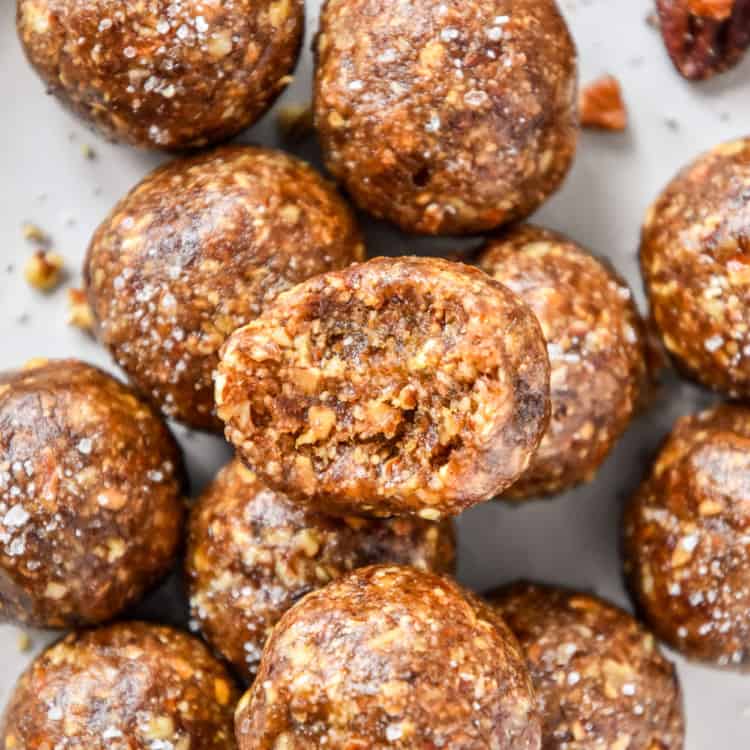 No Bake Pecan Pie Date Balls stacked on a plate.
