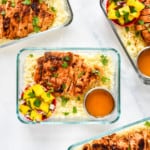chipotle lime chicken meal prep with mango salad in a glass meal prep bowl.