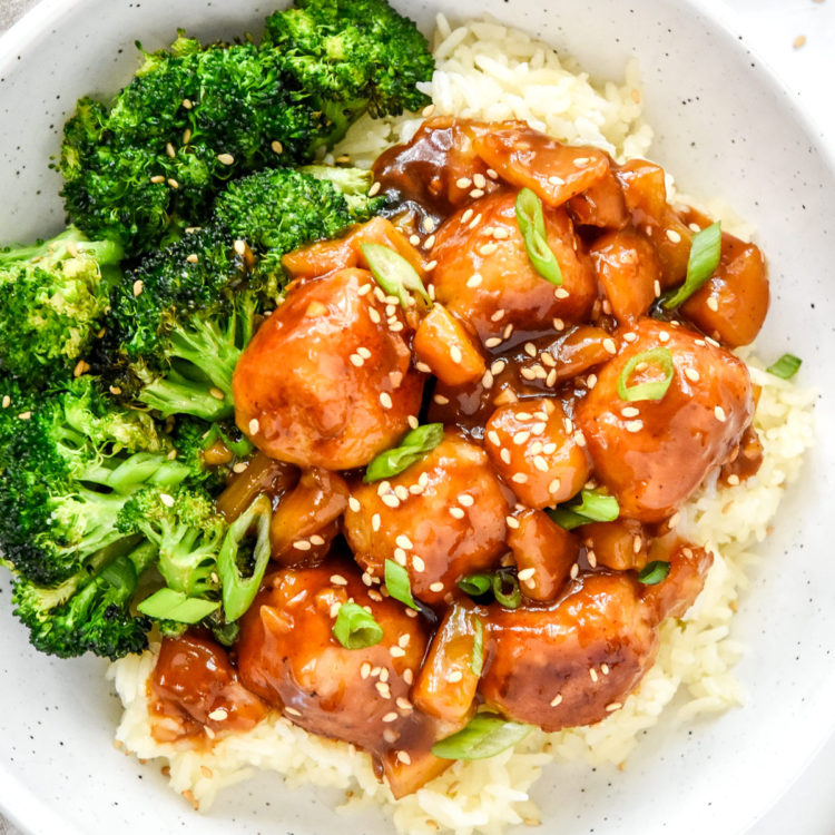 sticky saucy ground chicken meatballs with broccoli and rice in a bowl.