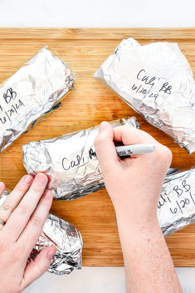 labeling breakfast burritos wrapped in foil.