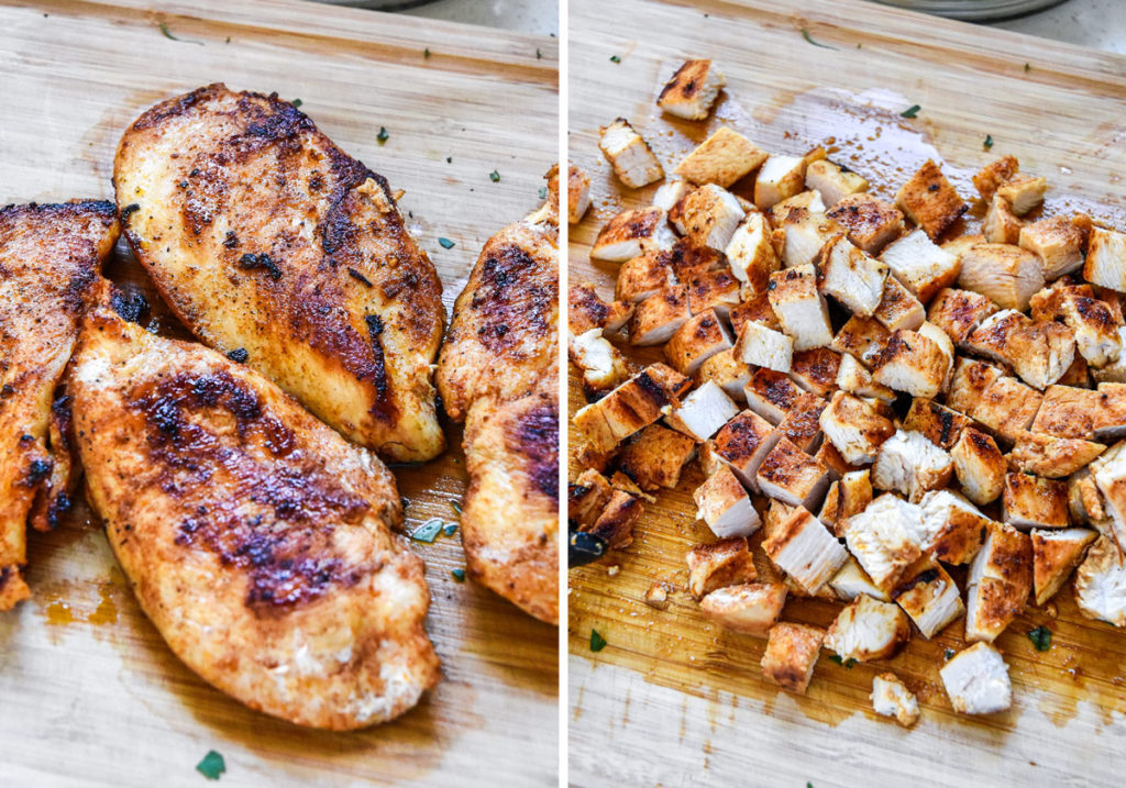 cooked and cut chicken breast on a cutting board.