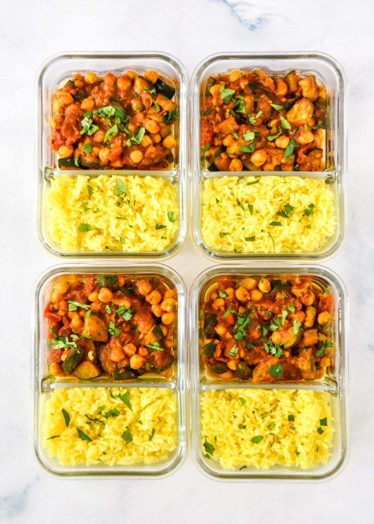 zucchini chickpea curry meal prep with turmeric rice and cilantro on top.